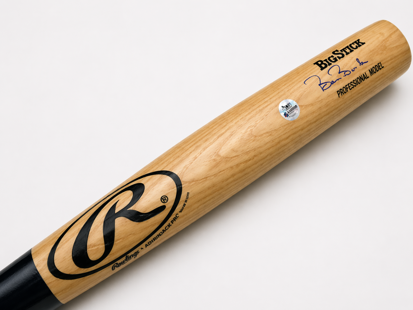 A wooden Rawlings Big Stick baseball bat with black branding, signatures, and a licensing sticker on a white background.