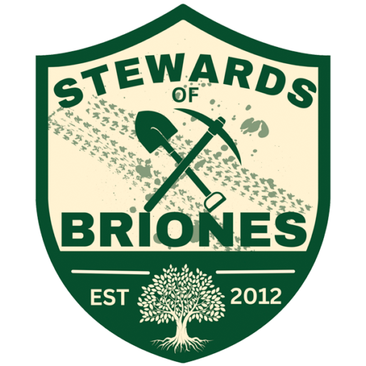 A shield-shaped logo with the text 'Stewards of Briones,' featuring a shovel and pickaxe crossing each other, a planting seed, and a tree at the bottom, with 'EST 2012'.