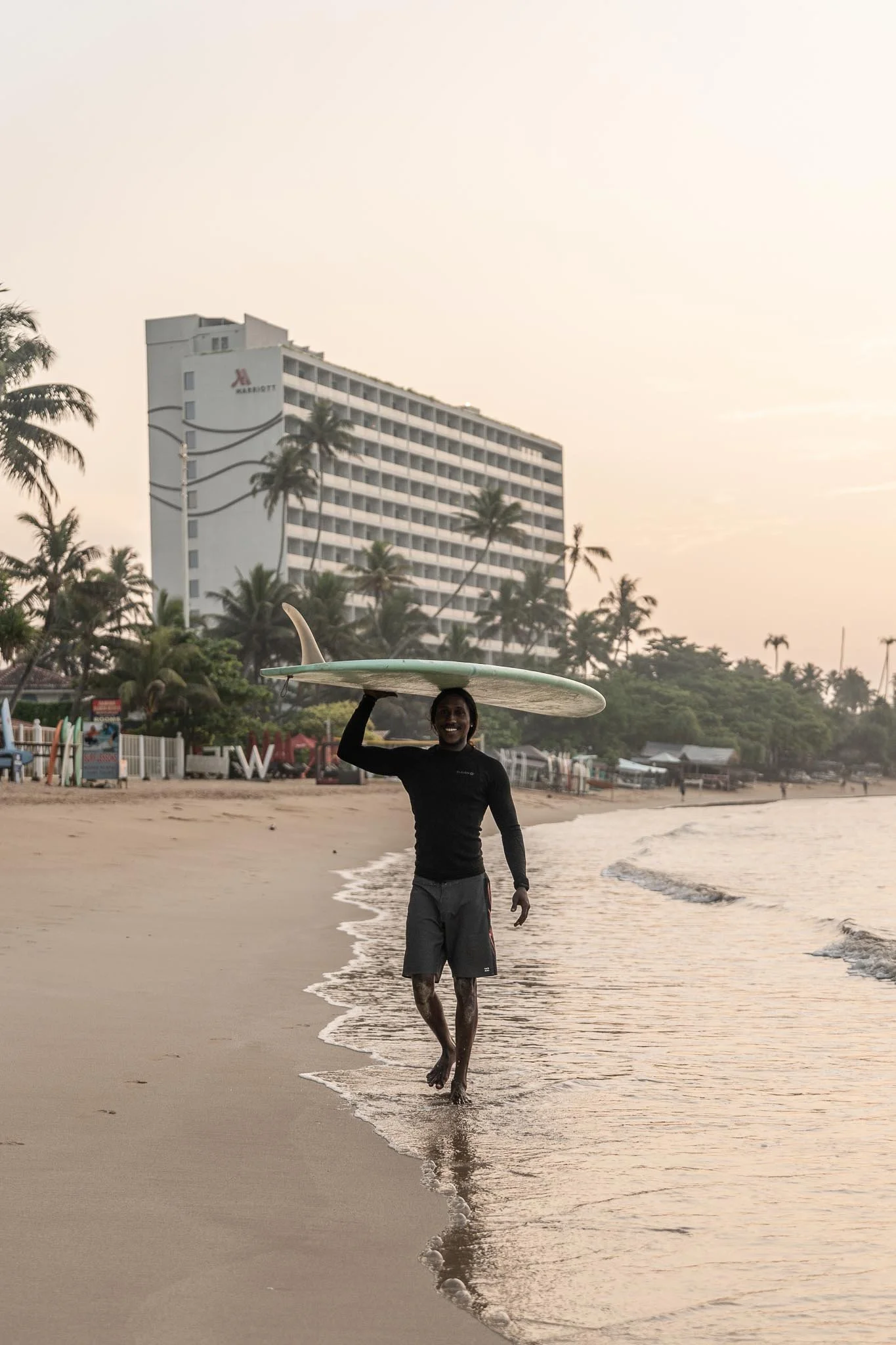 Anju our co-founder in Weligama bay with a longboard — Lanka Surf House