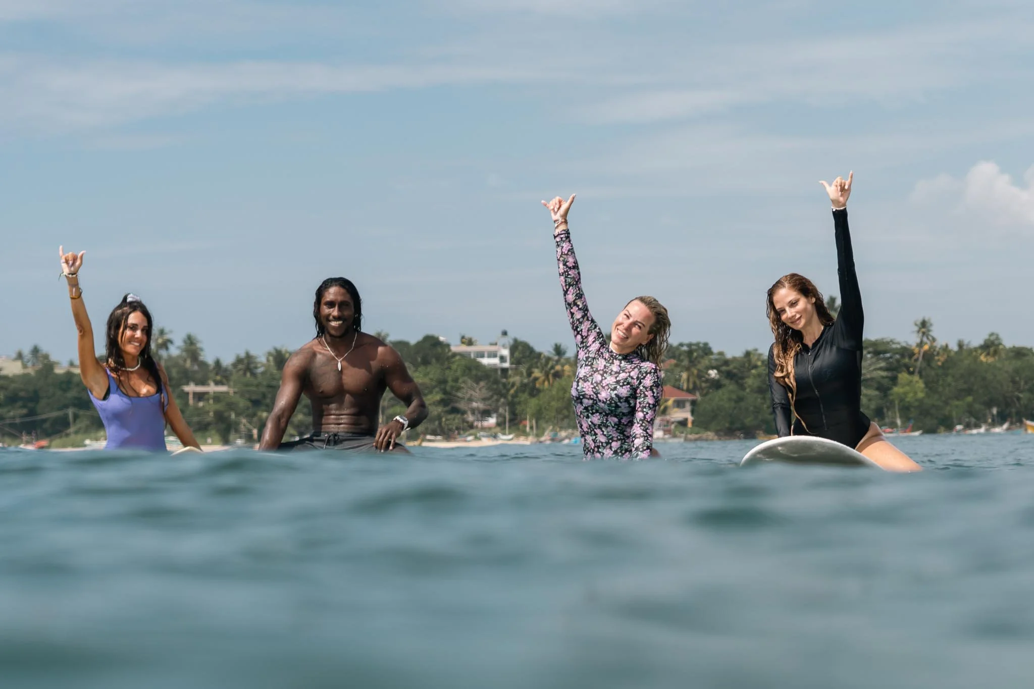 Some students with our co-founder Anju surfing in Weligama Bay — Lanka Surf House