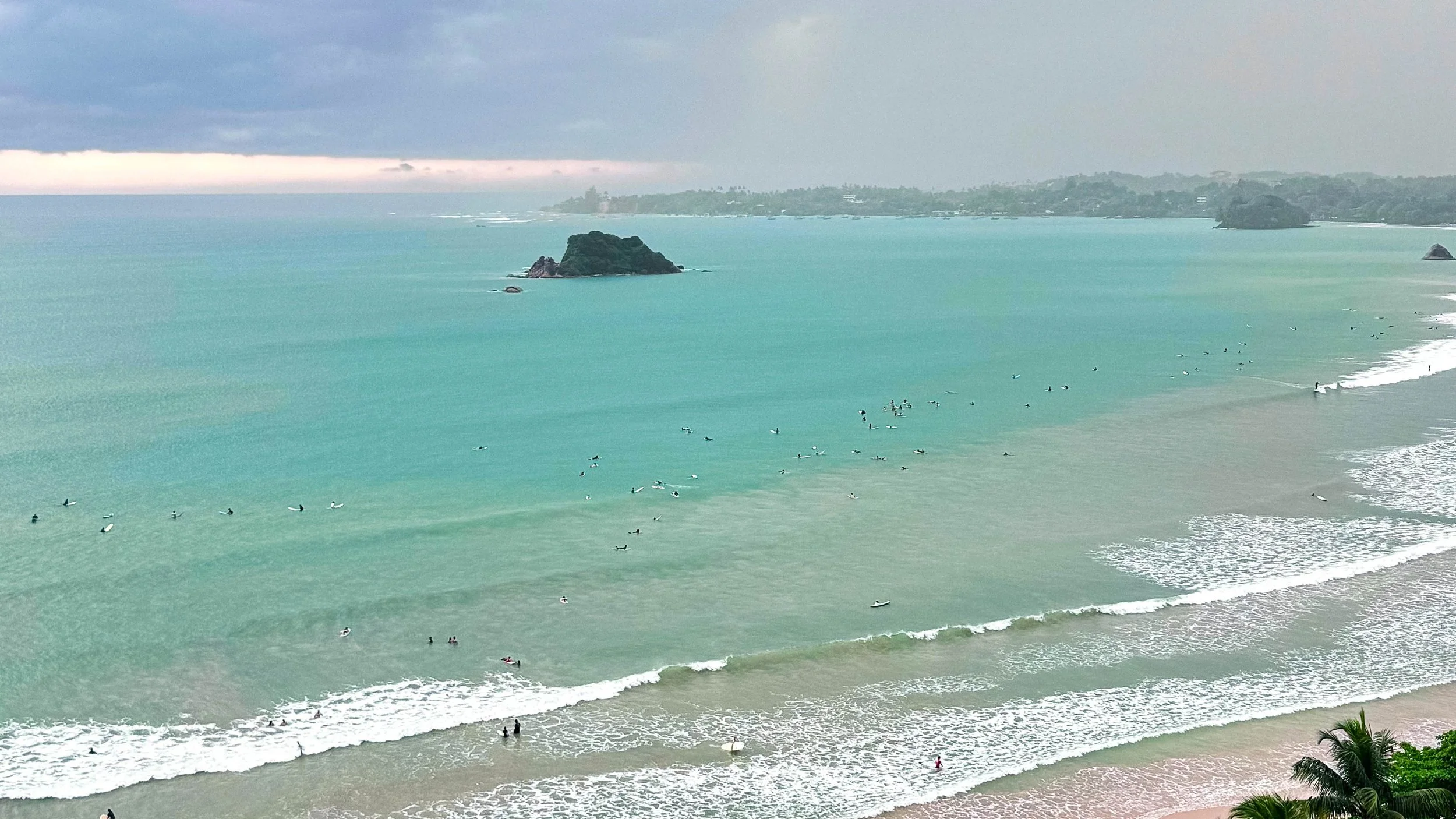 Aerial view of surfers at Weligama Bay beach break, Sri Lanka