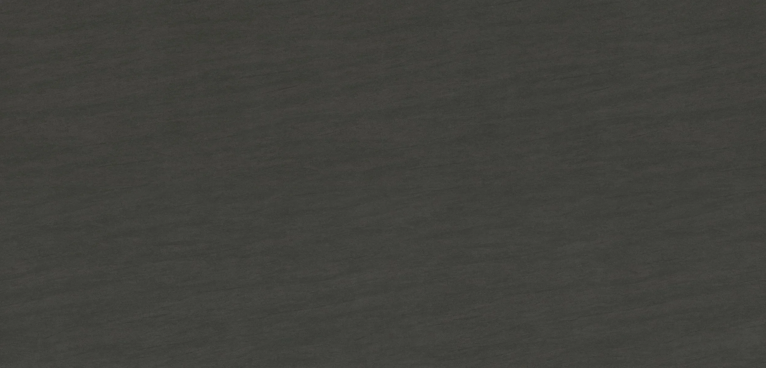 Das Bild zeigt eine schwarze Oberfläche, eventuell Holz oder Kunststoff, mit feiner Maserung.