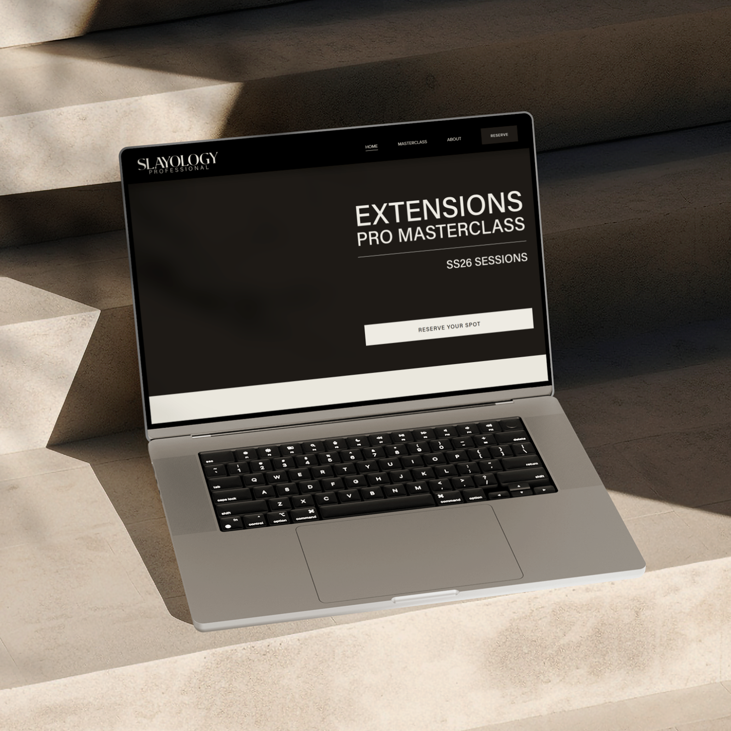 Slayology Pro website homepage on laptop, showing Extensions Pro Masterclass hero section