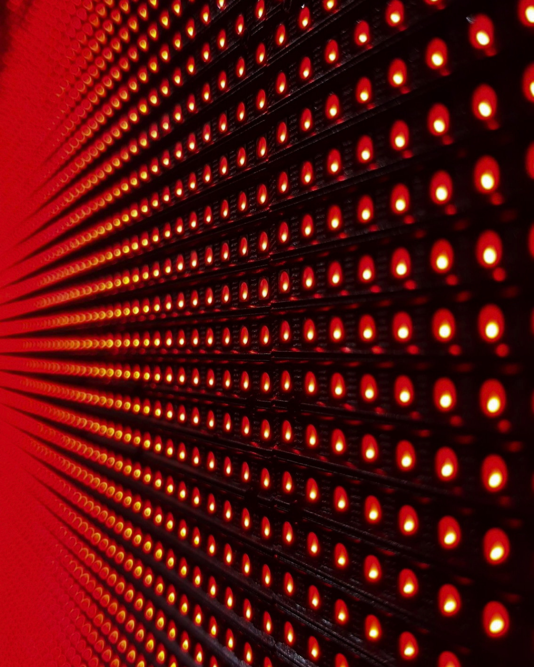 Close-up of a black LED display panel with numerous glowing red LEDs arranged in rows.