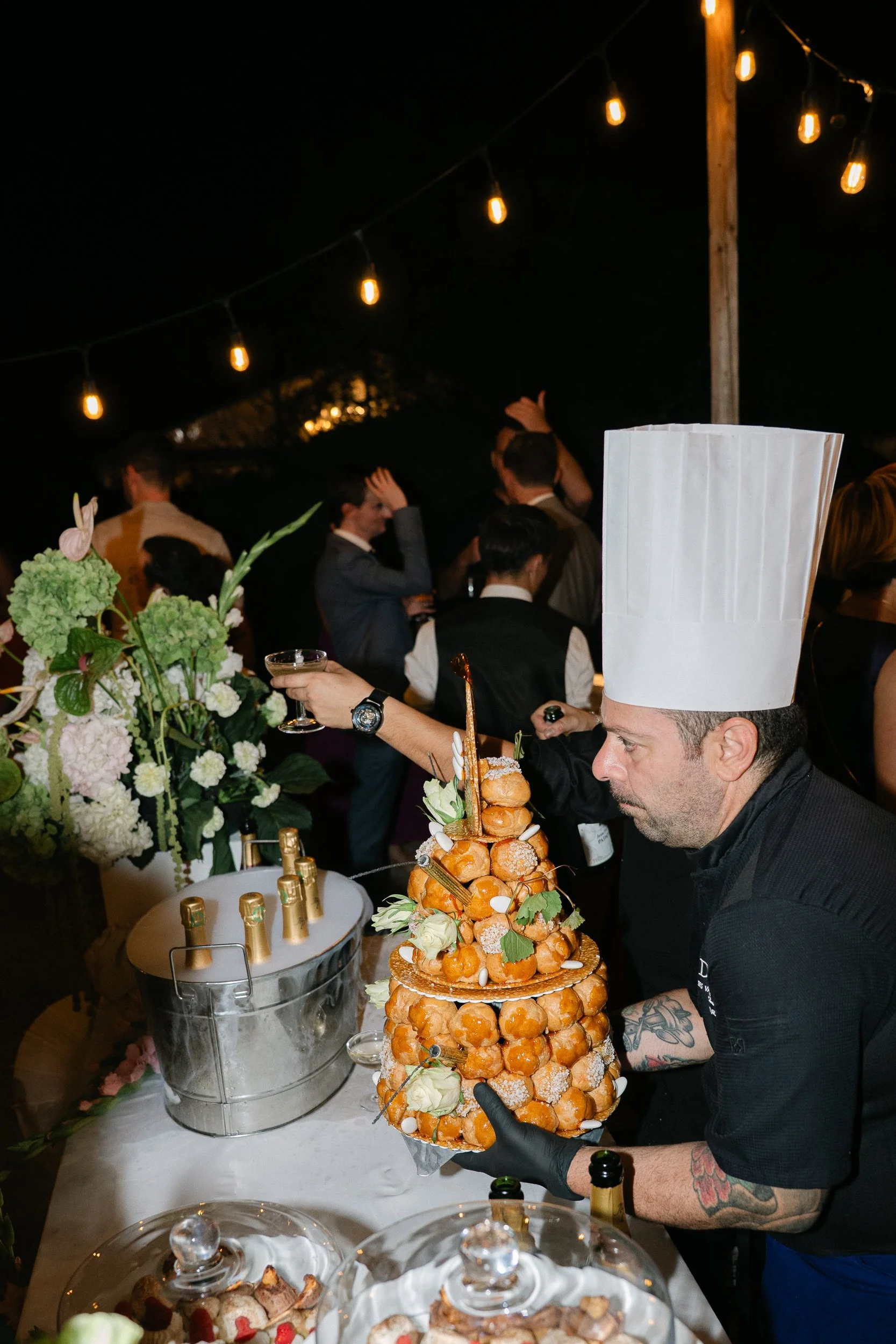 Chef presenting a croquembouche at the evening reception at Château Fengari
