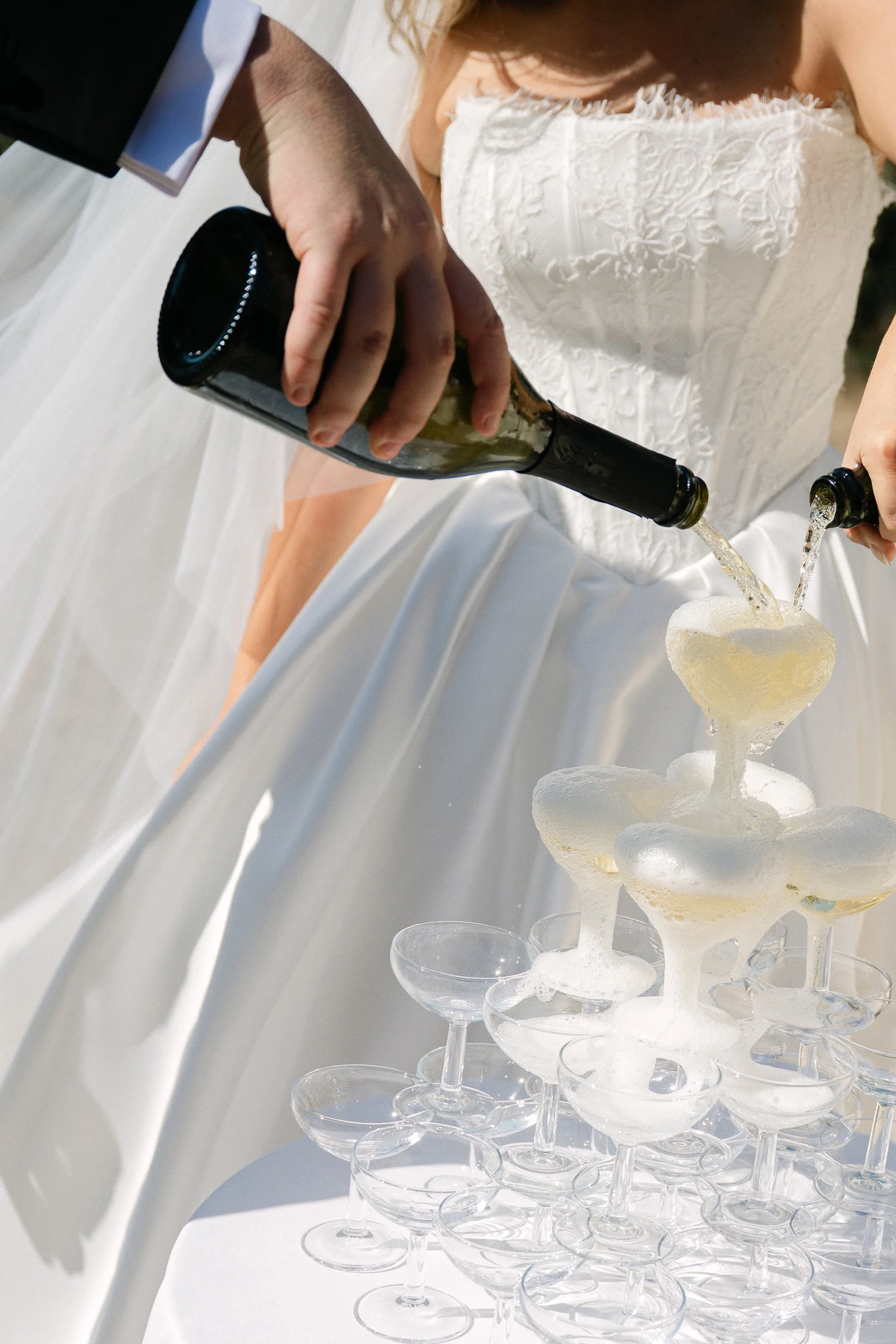 Champagne being poured into a stacked tower of glasses at Château de la Valouze