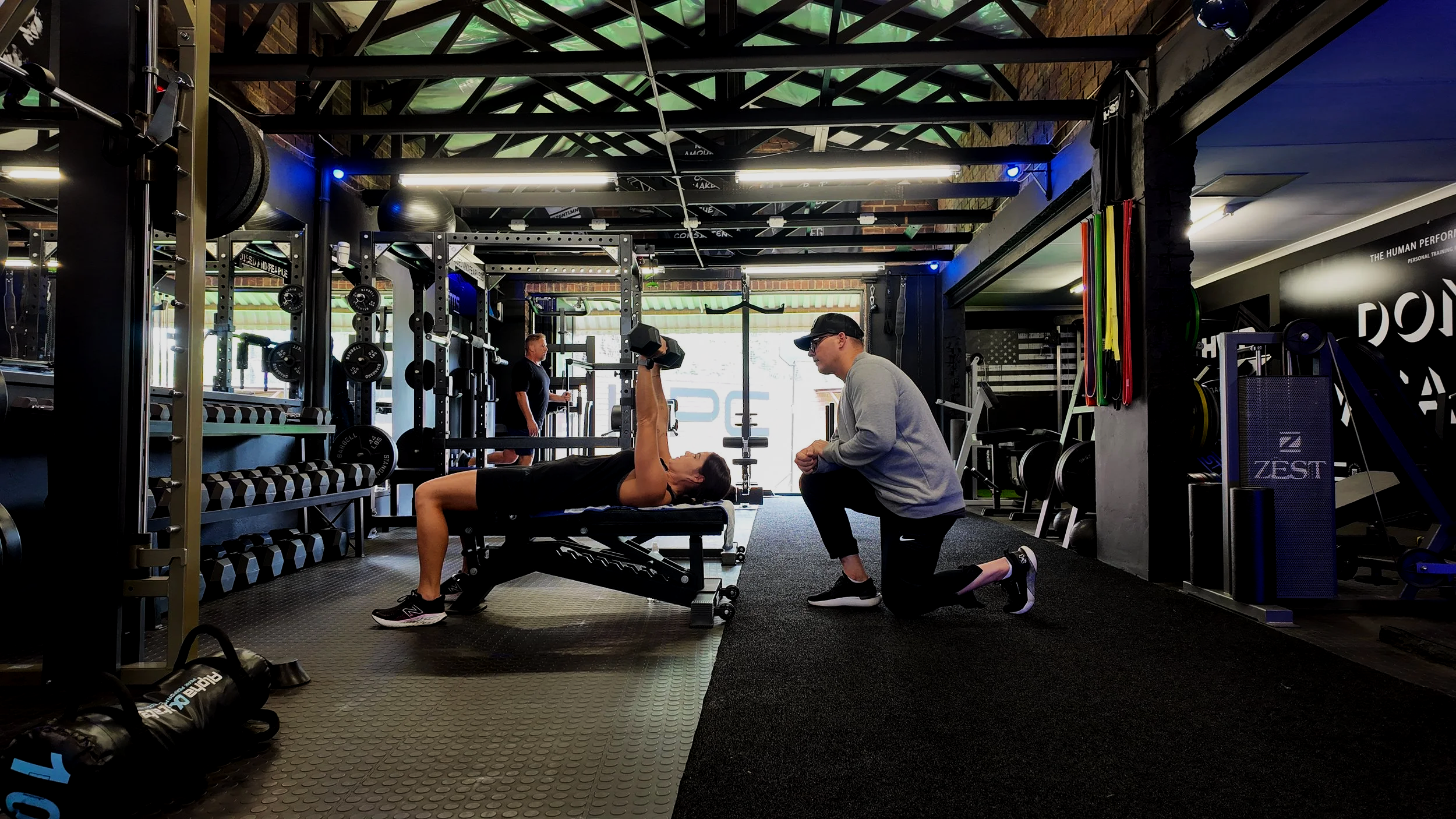 HPC trainer coaching a runner through a movement at The Human Performance Center