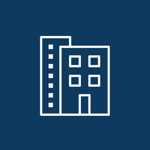 Icon of two buildings, one taller with a dotted line and one shorter with four windows and a door.