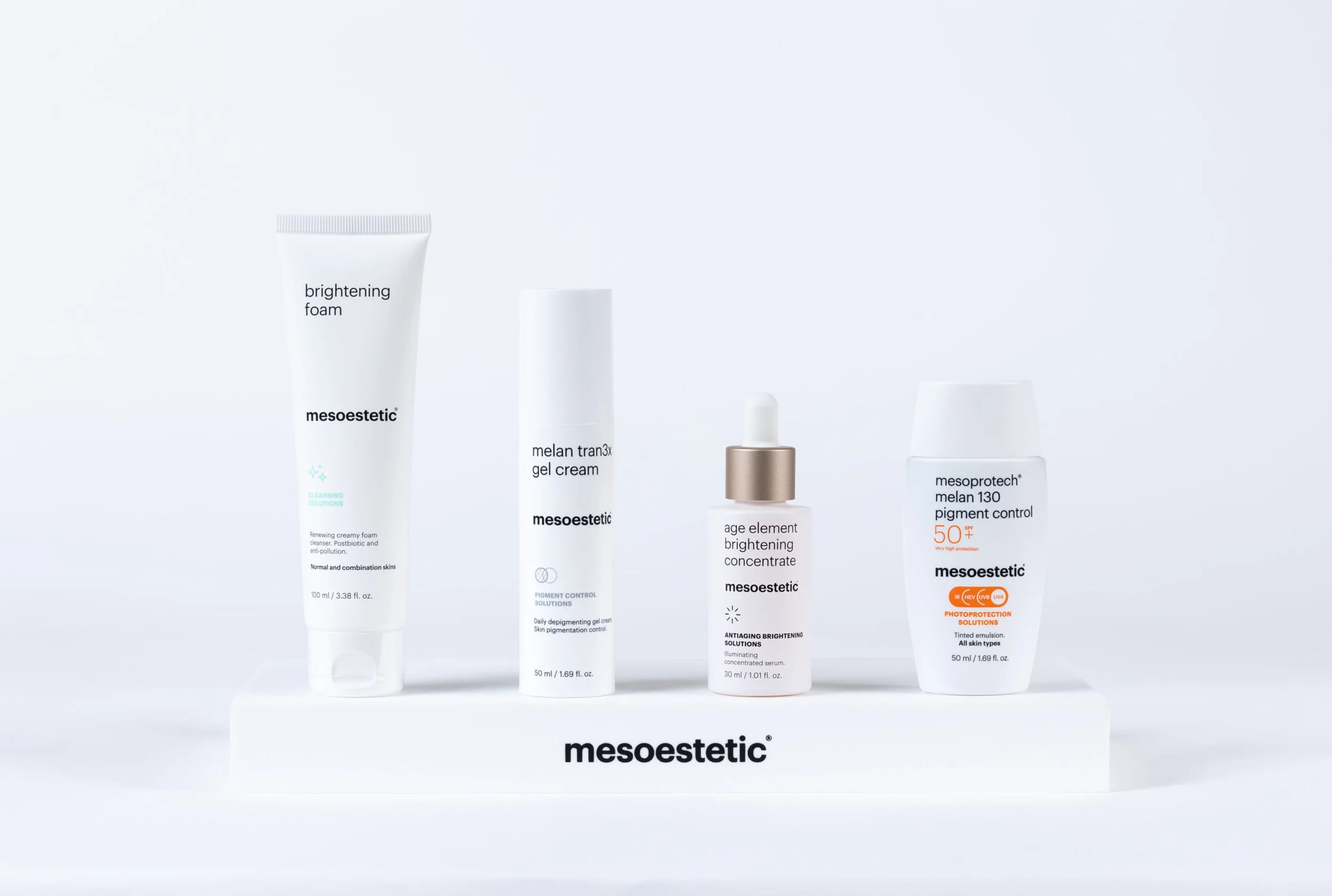 Collection of skincare products including a brightening foam, melanin gel cream, brightening concentrate, and high protection solution, all placed on a white display stand against a white background.