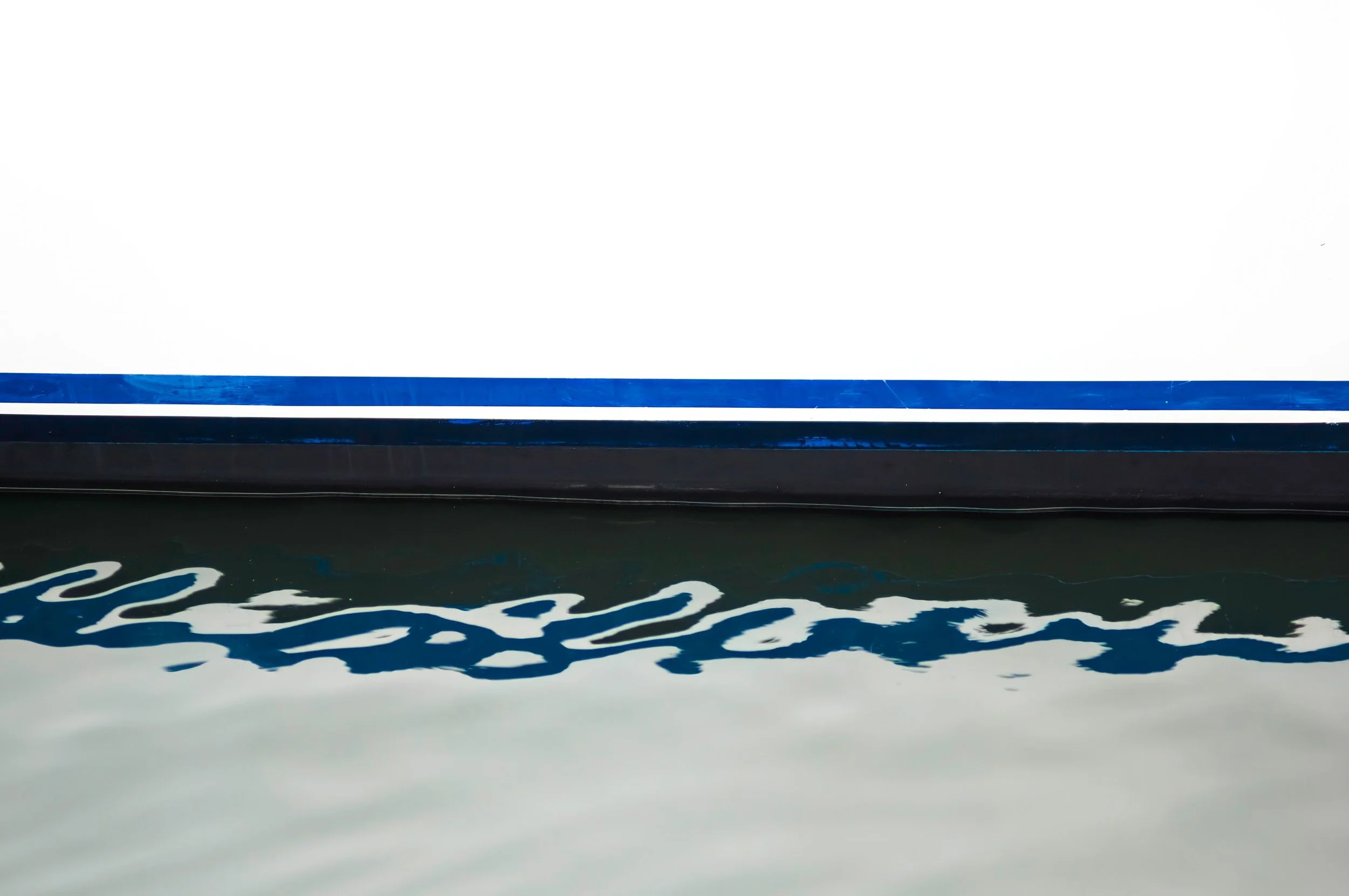 Abstract water surface with reflections and ripples — Kimberly Poppe fine art photography, her Eventides seascape series, is permanently installed at Hotel Arts Barcelona