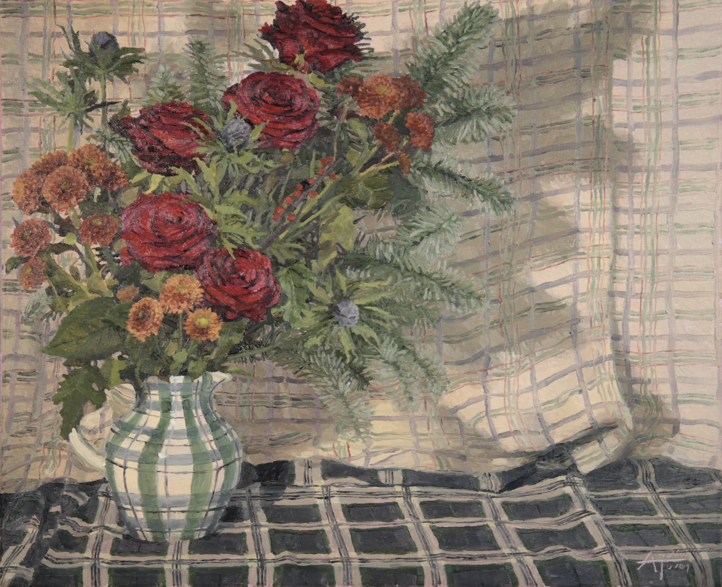 A floral arrangement in a glass vase on a table with a woven, plaid tablecloth. The bouquet includes red roses, orange chrysanthemums, and other greenery.