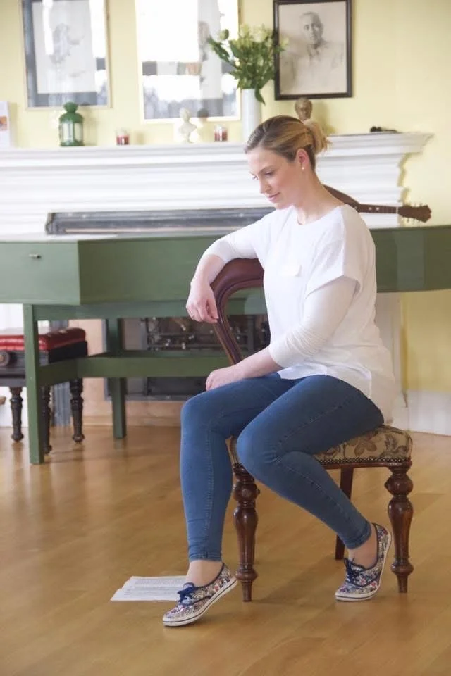 Lesley Buchan, soprano and vocal coach, seated in a masterclass with a harpsichord in the background