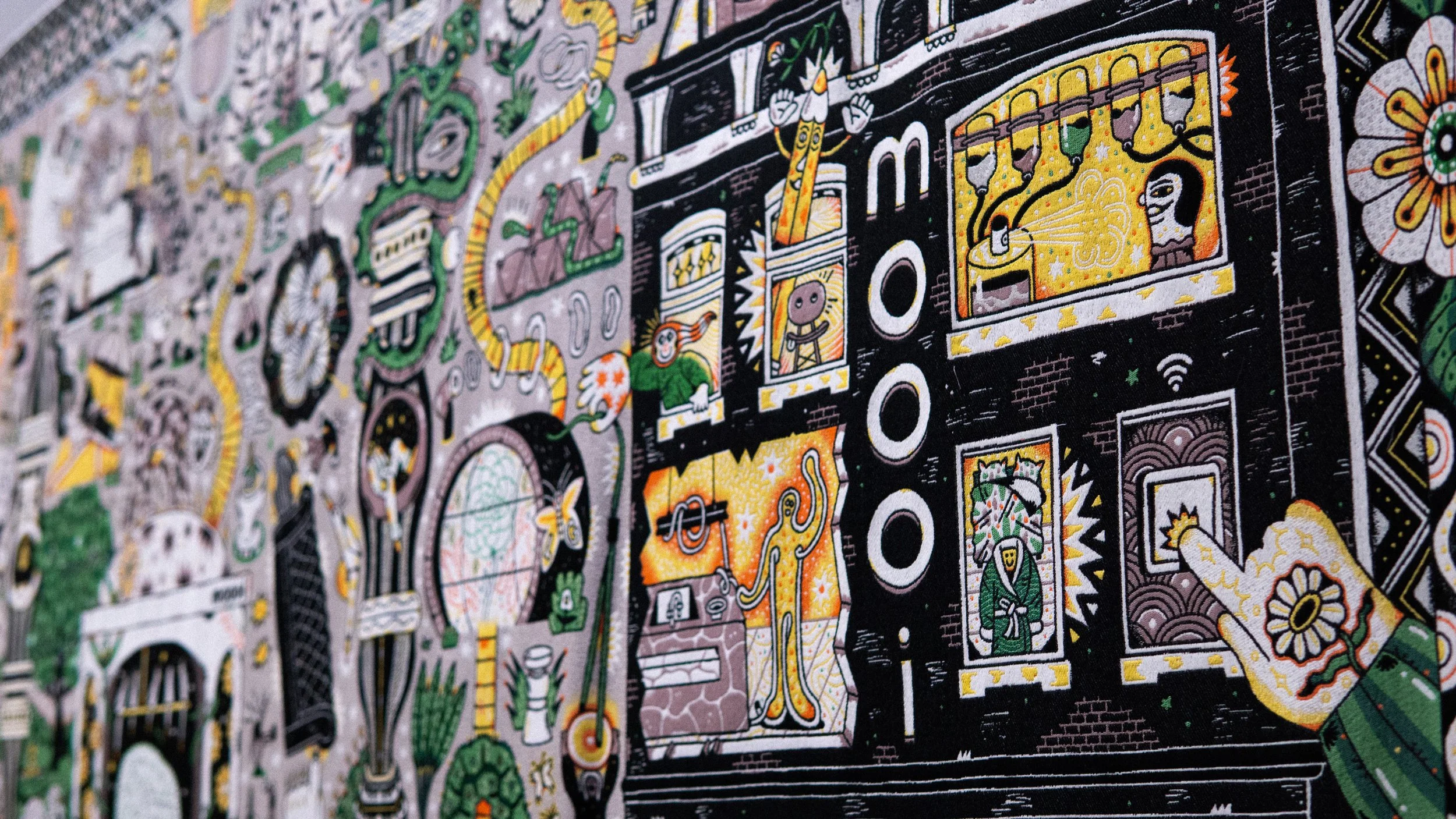 Colorful, detailed street art mural featuring various abstract and cartoon-style characters, objects, and patterns with prominent black, yellow, green, purple, and white colors.  Tapestry and jacquard weaving art