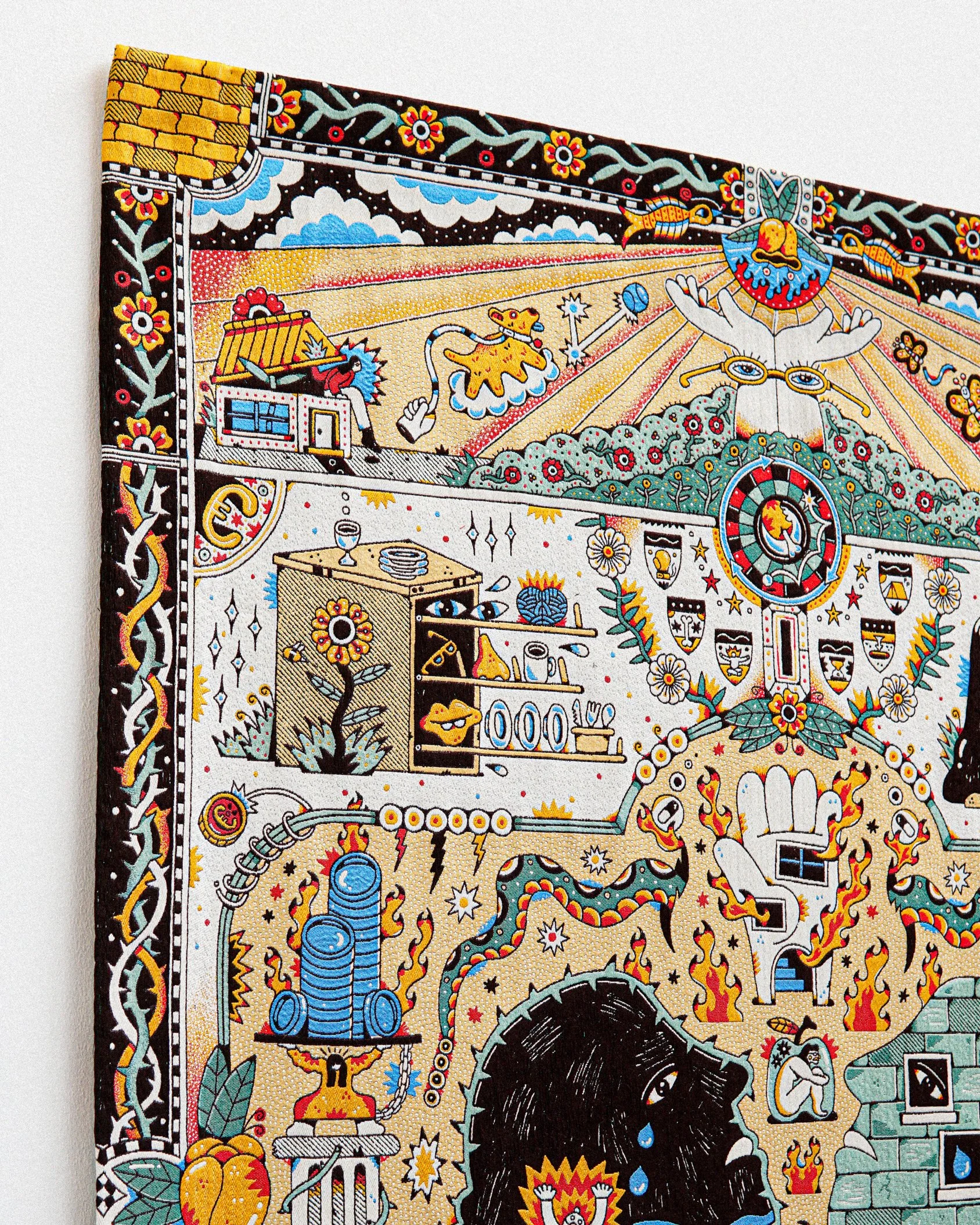 A colorful, detailed illustration of a traditional Mexican Day of the Dead artwork featuring decorative skulls, flowers, and cultural symbols on fabric or paper.