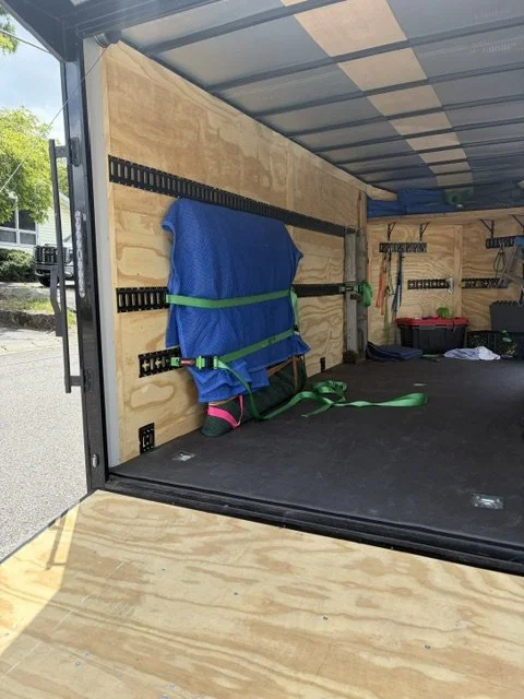 Heavy six-foot by six-foot oil painting fully padded and secured to E-track inside Slohaven Transfer's enclosed trailer.