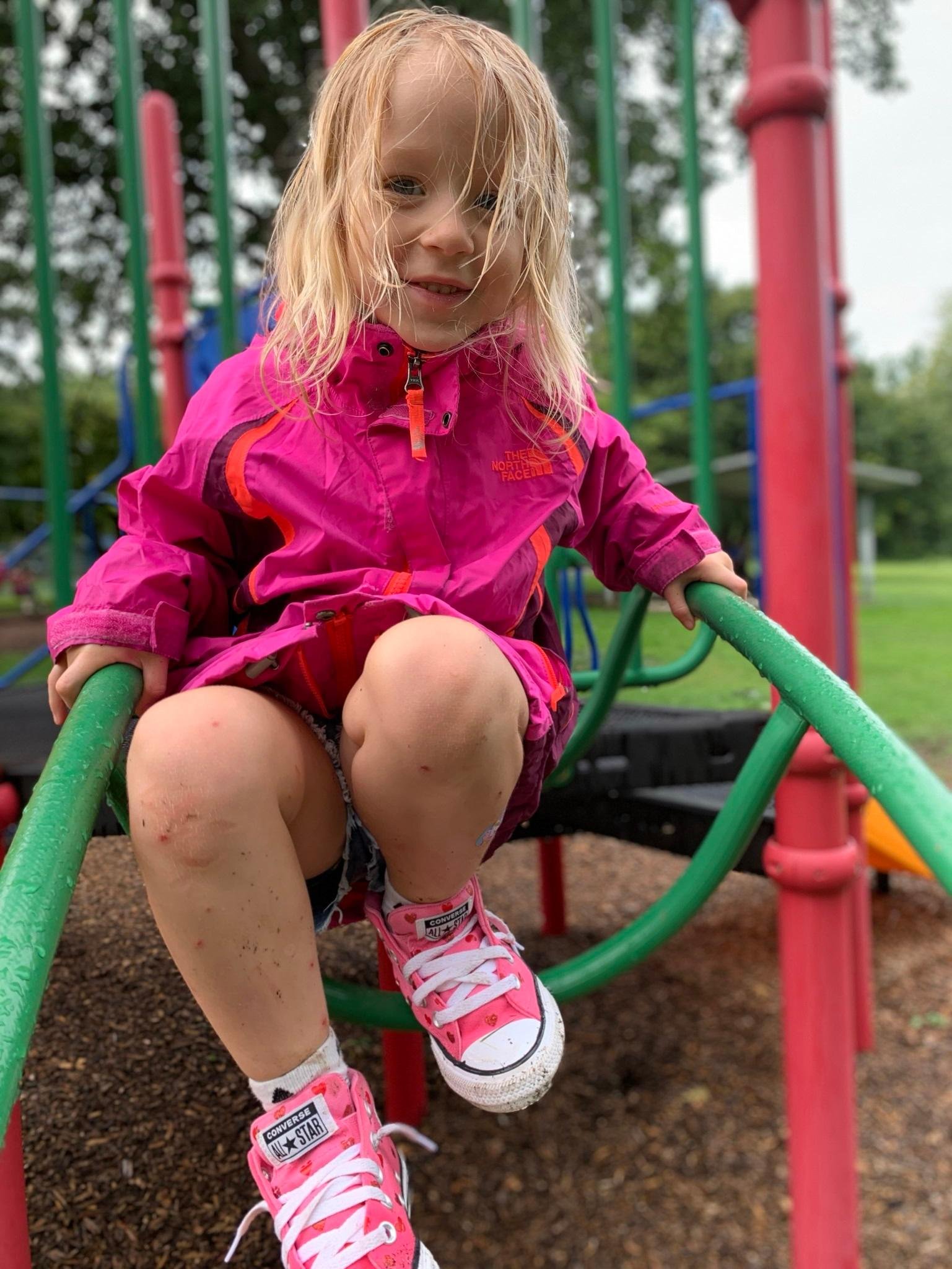 student gets a little muddy on a public park climber
