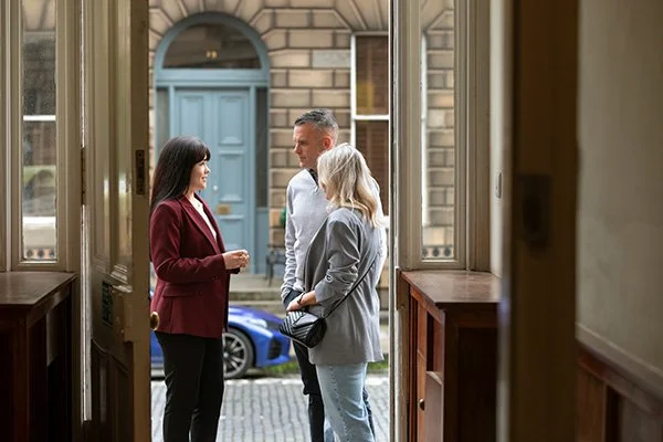 mortgage broker in edinburgh city centre talking through insurance protection with buyers