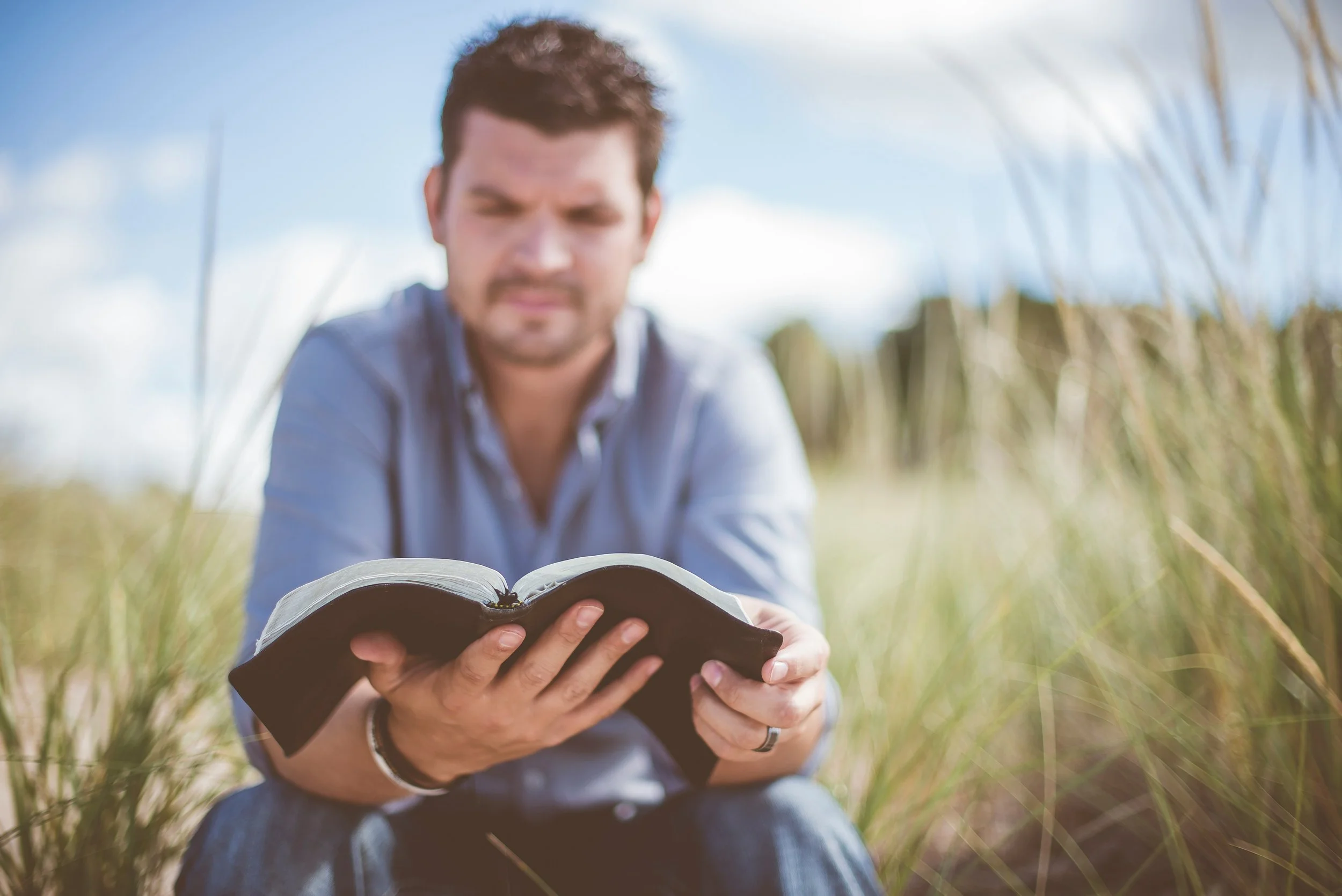 Man reading his Bible as an ROCD compulsion
