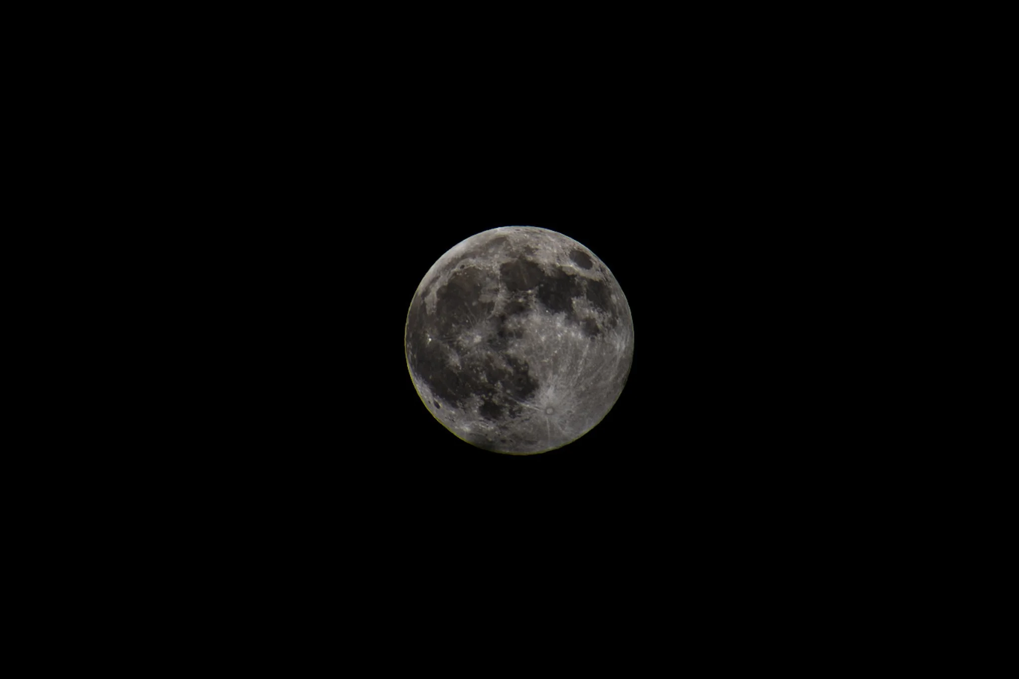 Full moon seen against a dark night sky.