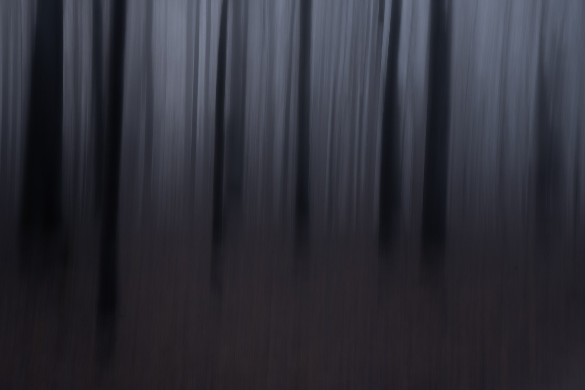 Close-up of black piano keys with a dark background.