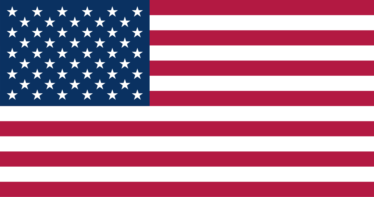 An American flag with blue canton containing white stars and red and white stripes.
