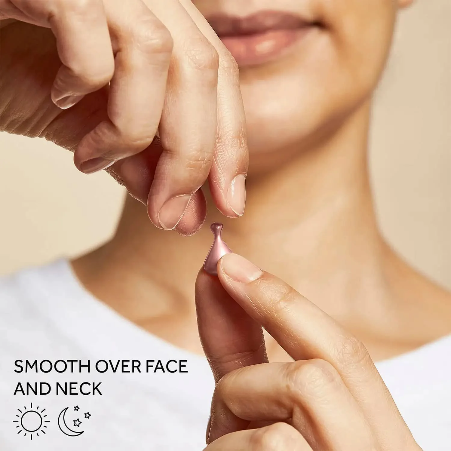 A person holding a pink facial roller near their face, demonstrating skincare application.