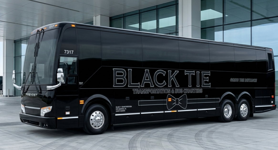 Black bus with white lettering that says 'Black Tie Transportation & Bus Charters' and a bowtie graphic, parked outside a modern building.