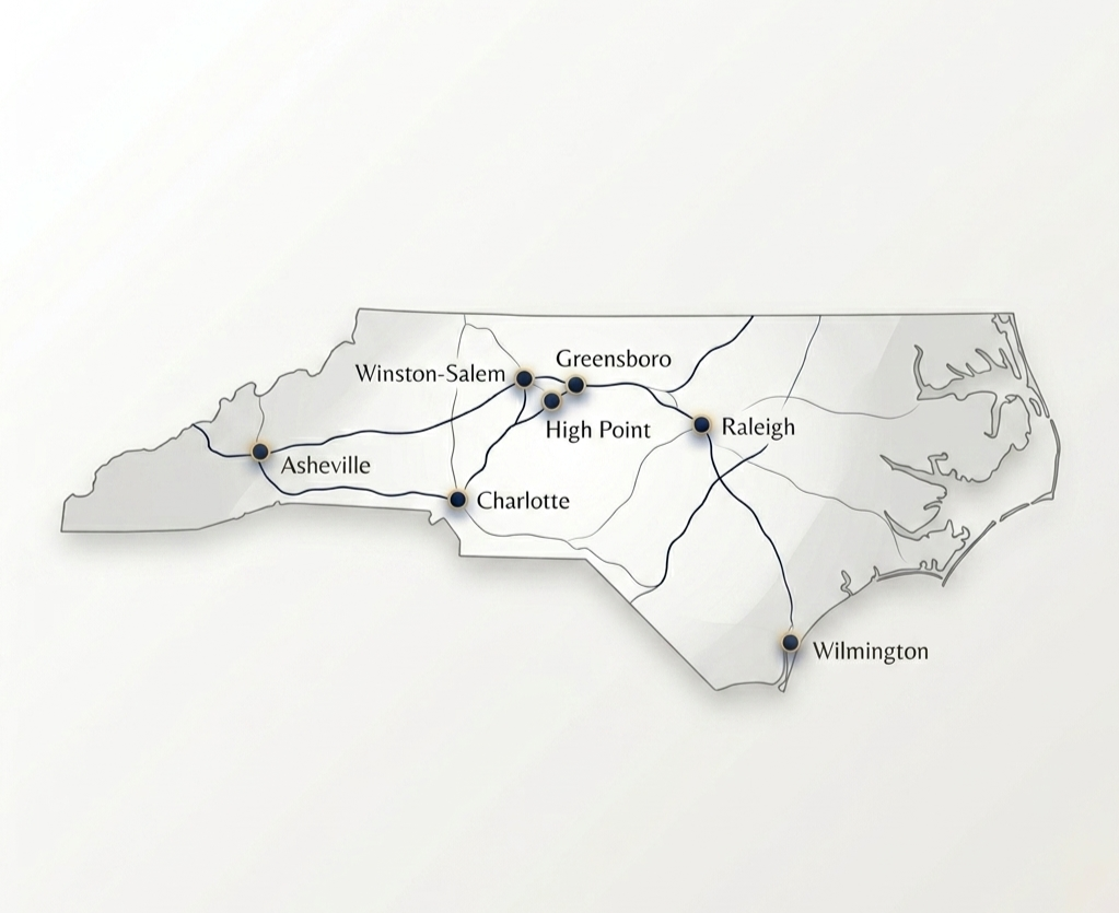 Map of North Carolina showing major cities: Asheville, Winston-Salem, Greensboro, High Point, Charlotte, Raleigh, Wilmington, with railway lines connecting them.
