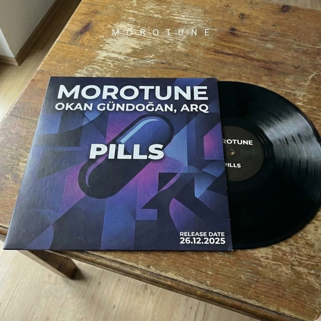 A vinyl record and an album cover titled "PILLS" by Morotune, Okan Gundoğan, Arç. The release date is December 26, 2025, and the album is on a wooden surface.