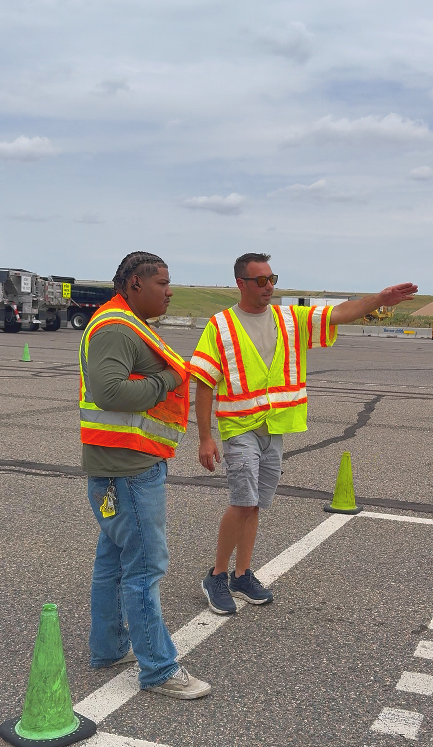 A CDL instructor is showing a CDL student how to do the basic skills maneuvers
