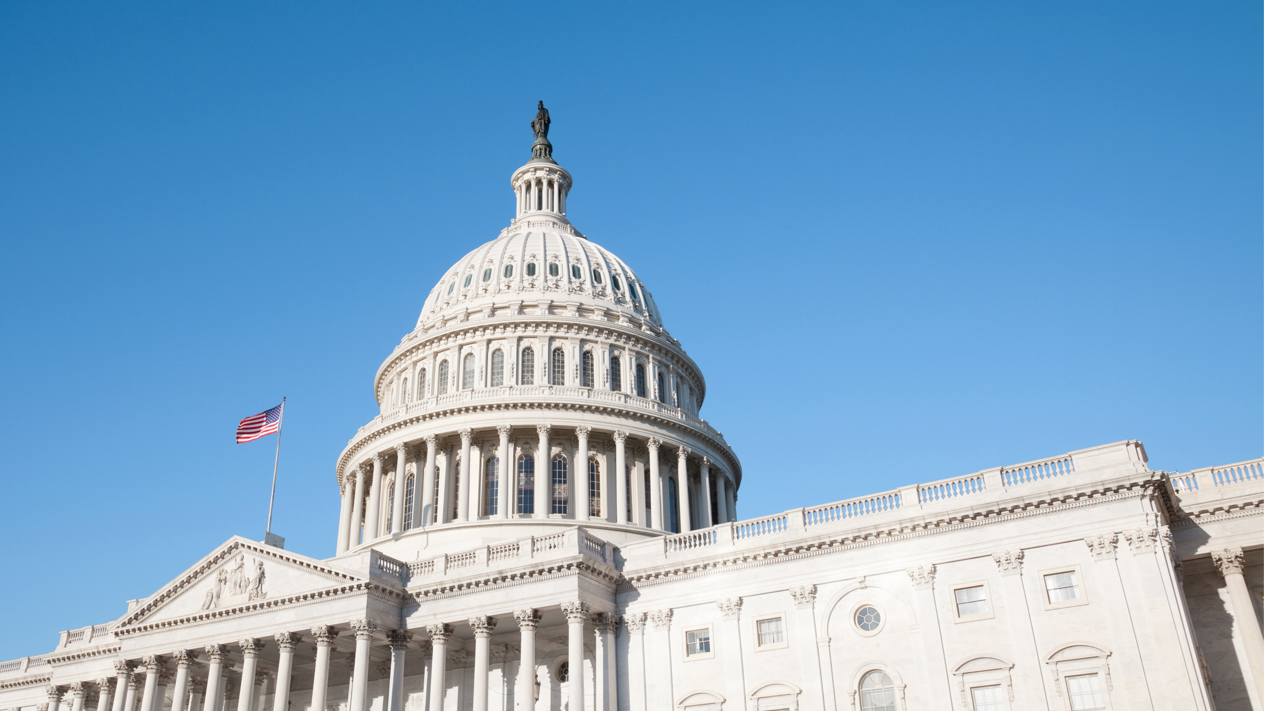 The United States Capitol building with an American flag and a clear blue sky in the background to show FFTA Policy in action.