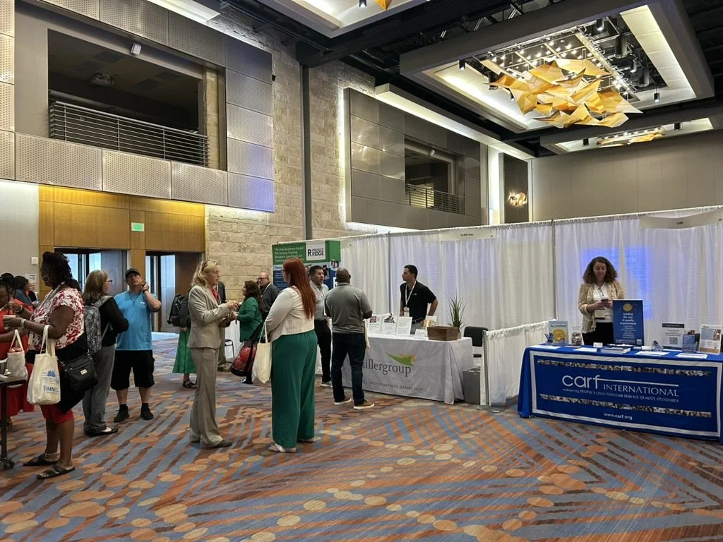 People interact at FFTA sponsor vendor booths in a convention hall with informational displays and promotional materials.