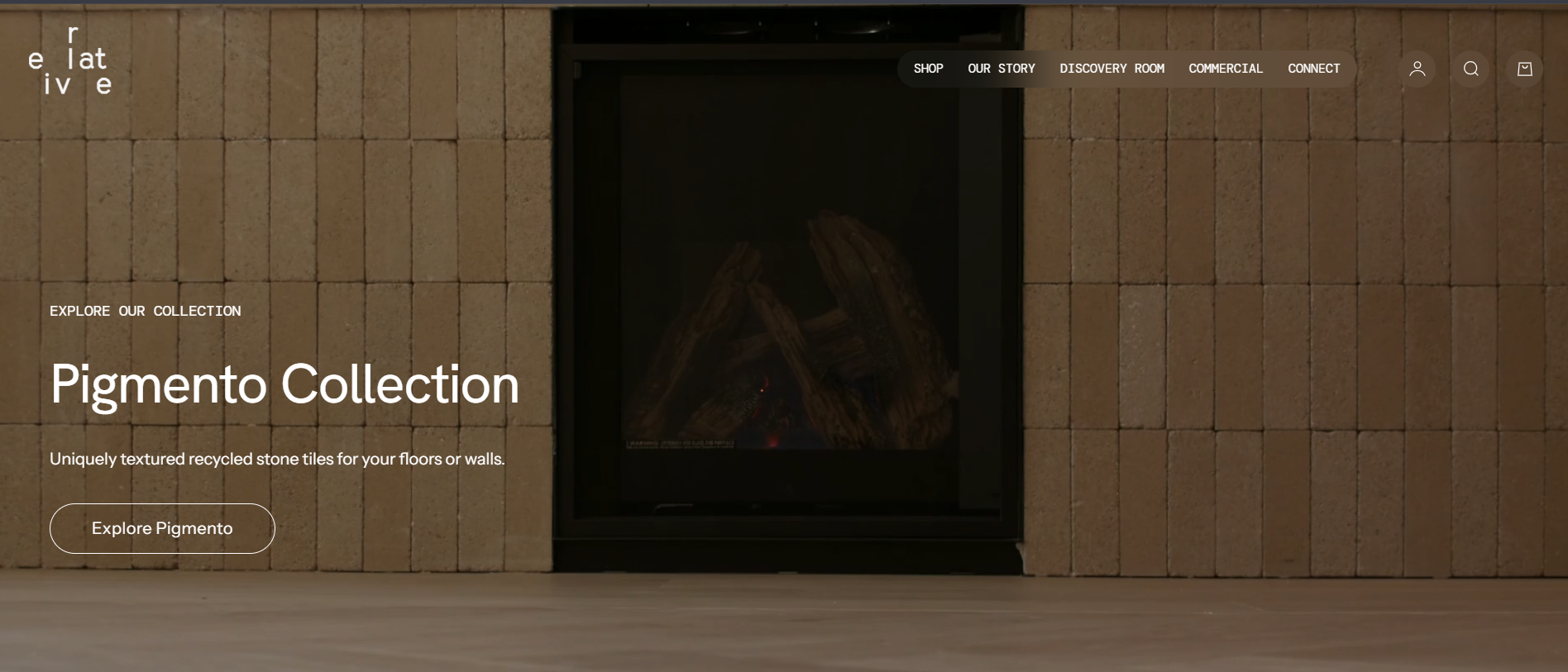 Homepage of a website featuring a fireplace with a wall of textured stone tiles, and text promoting the Pigmento Collection of recycled stone tiles.