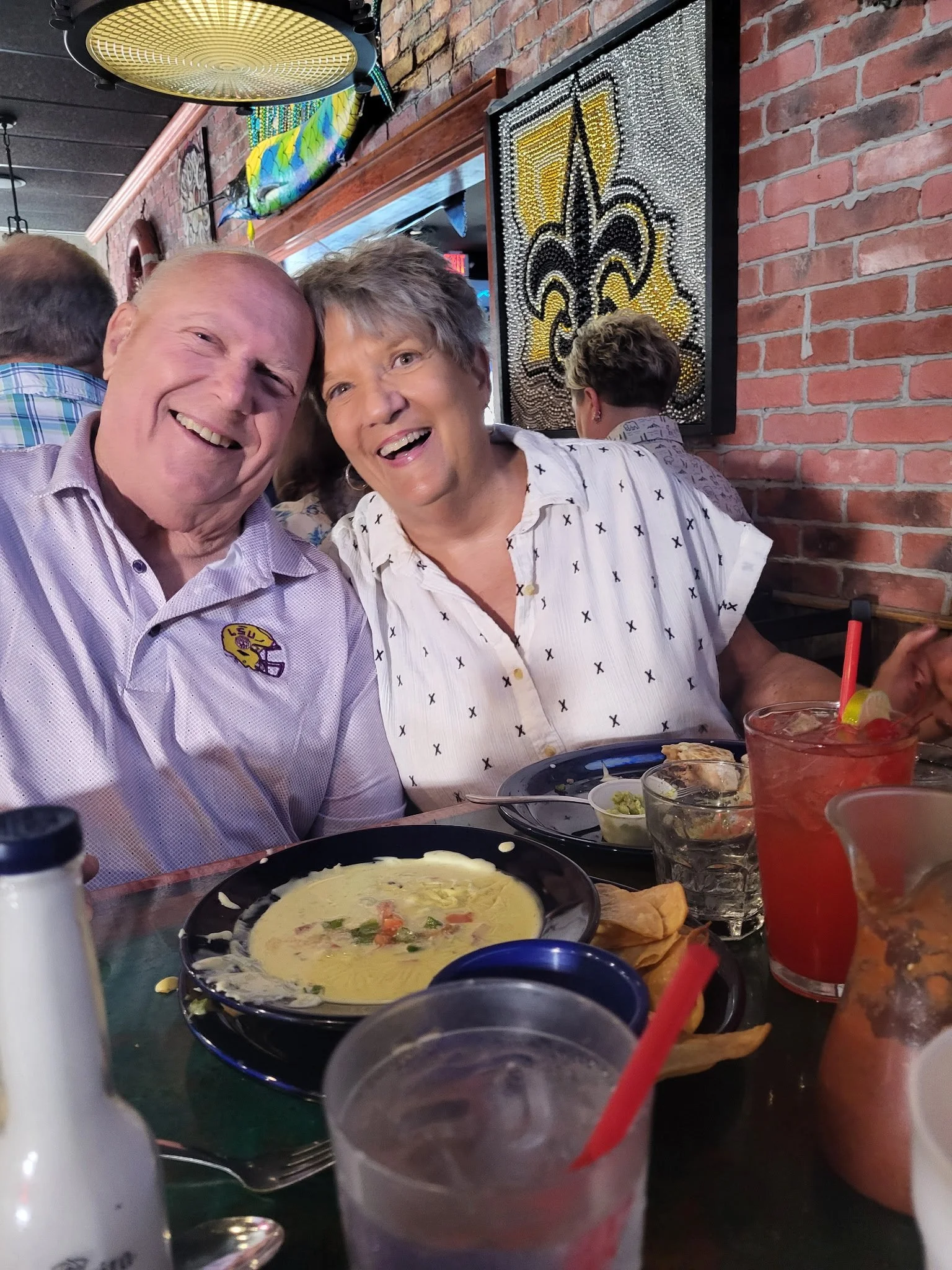 A husband and wife enjoying queso and drinks at The Oyster Bar & Grille. In Shreveport, Louisiana