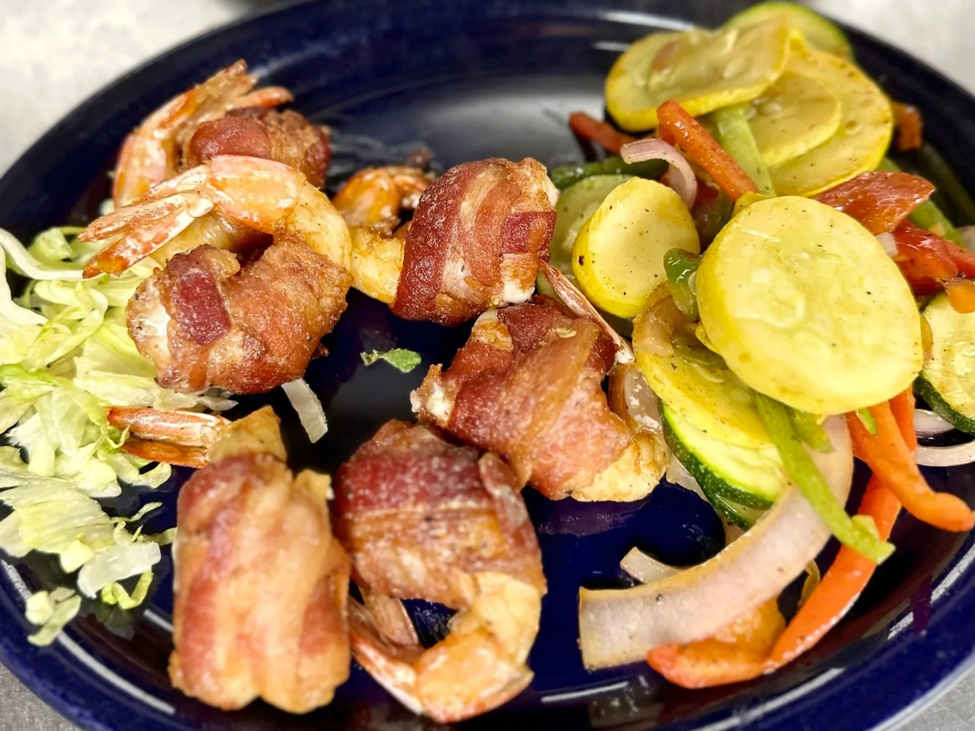 grilled gulf shrimp wrapped in bacon and stuffed with pepper jack cheese served with grilled vegetable medley