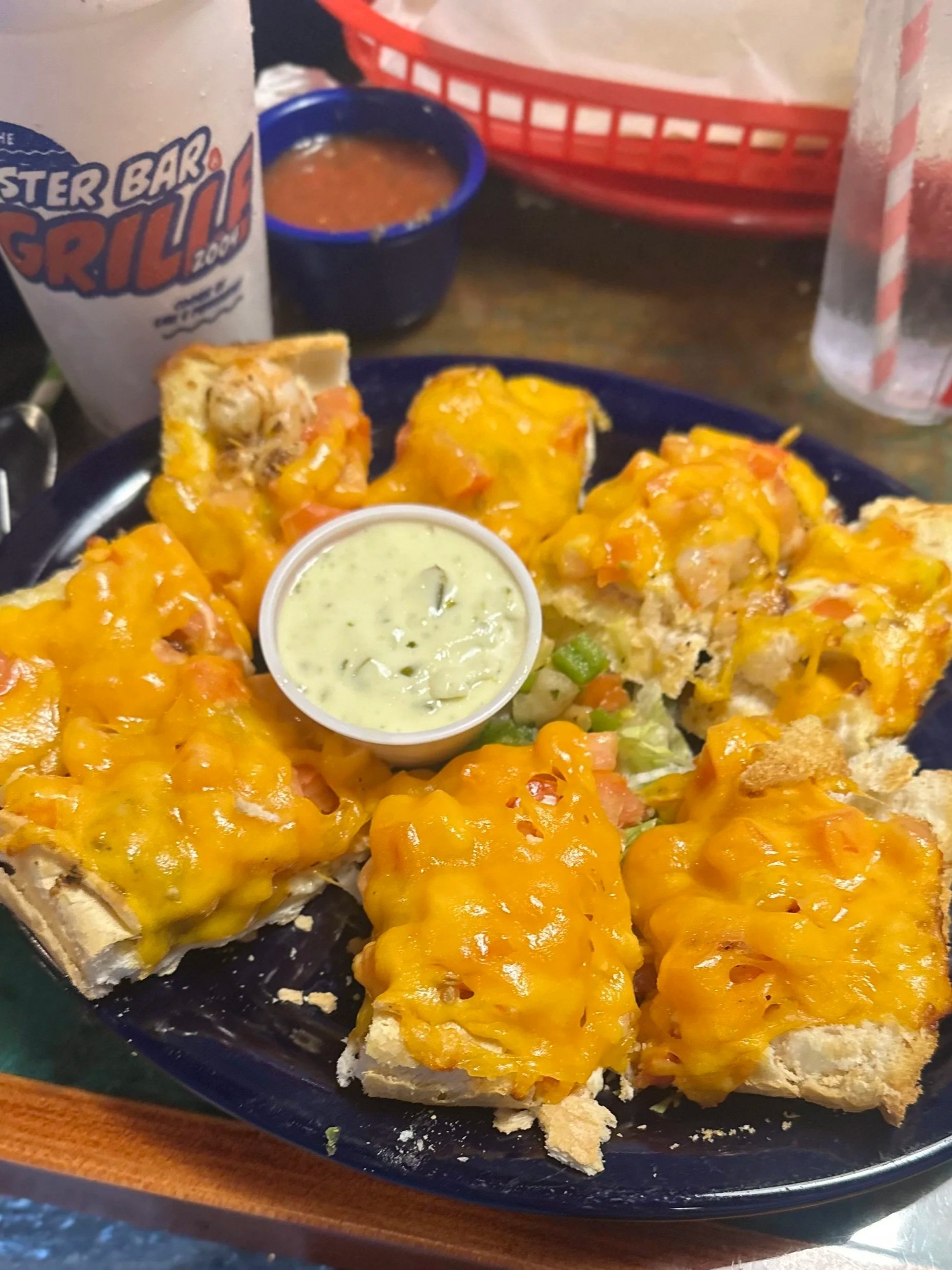 lucky bread tartar sauce toasted bun with or without protein, topped with cheddar cheese and lettuce baked to perfection