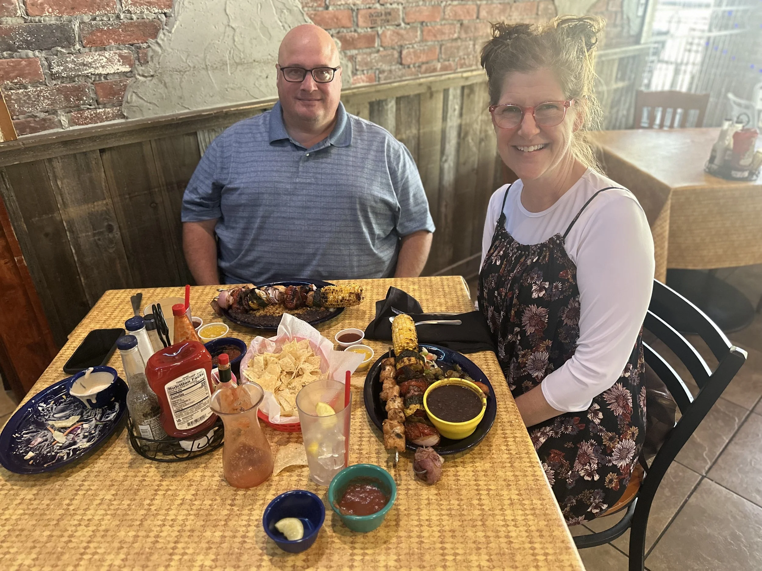 bald man and wife enjoying grilled kabobs at the oyster bar grille dining room