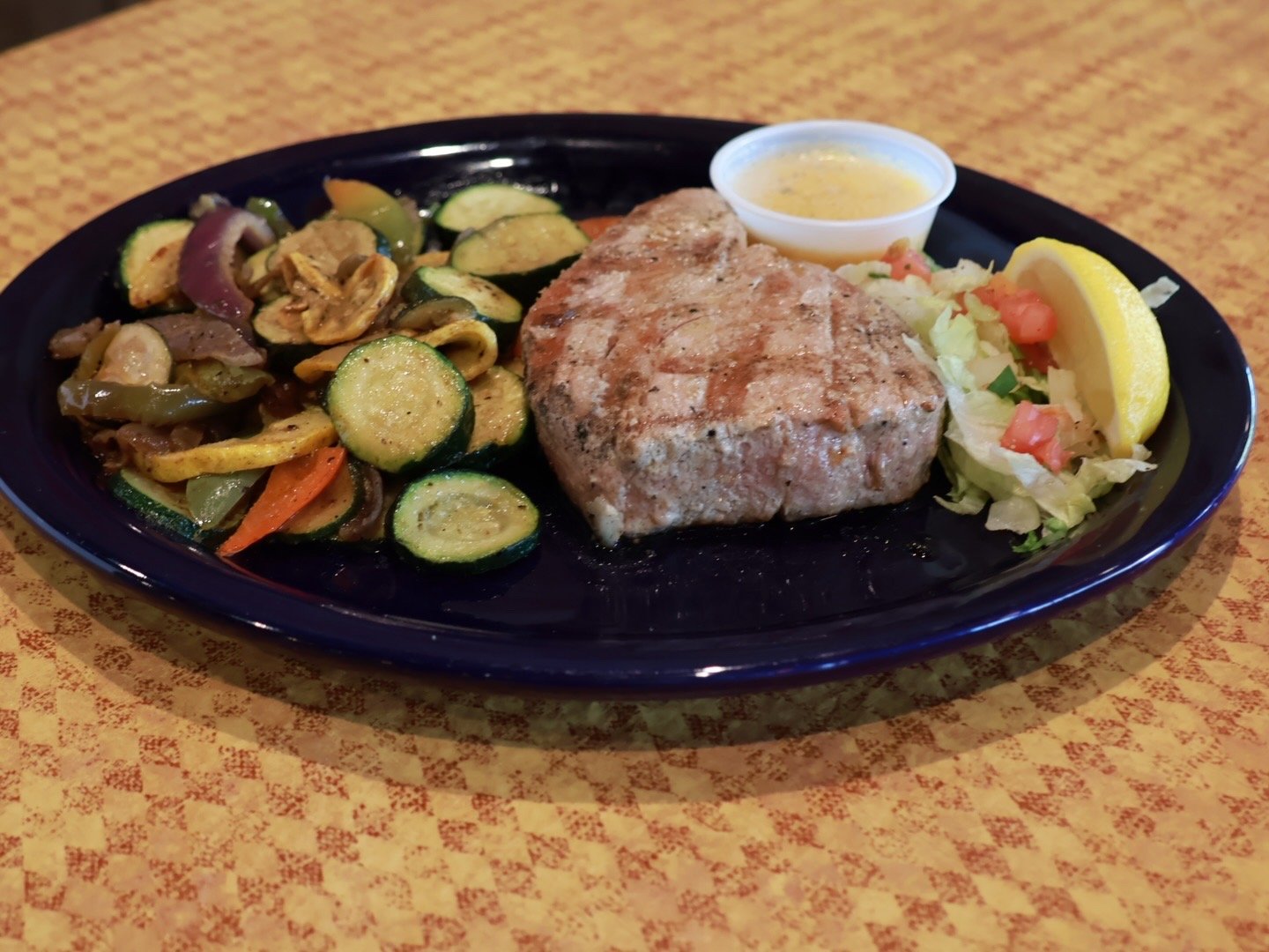 tuna steak cooked medium rare with grilled vegetable medley and chardonnay butter for dipping