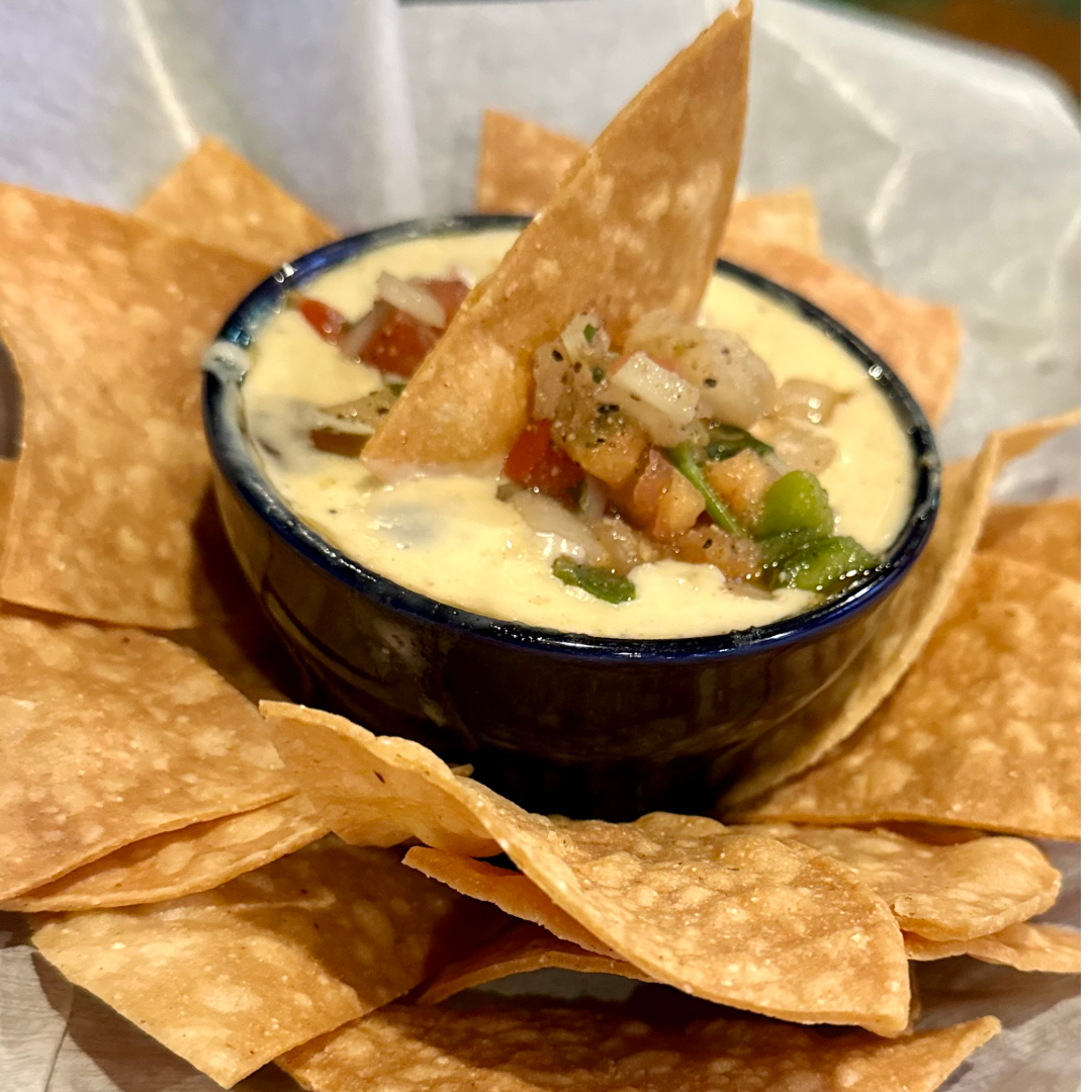 white queso house secret receipe served with pico de gallo and house fried corn chips