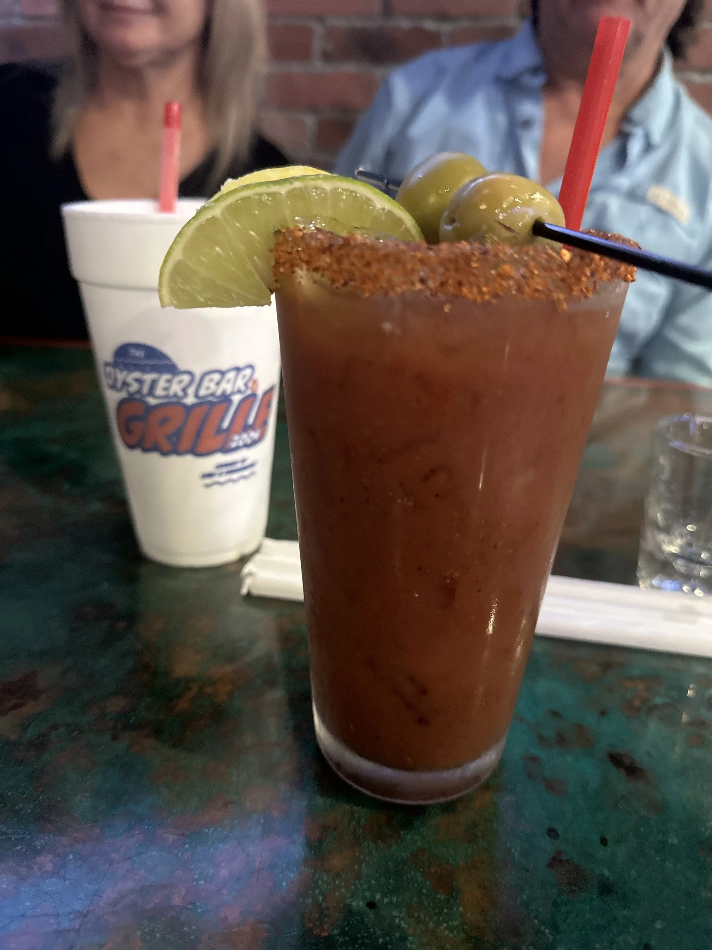 bloody mary topped with lime and olives your choice of vodka
