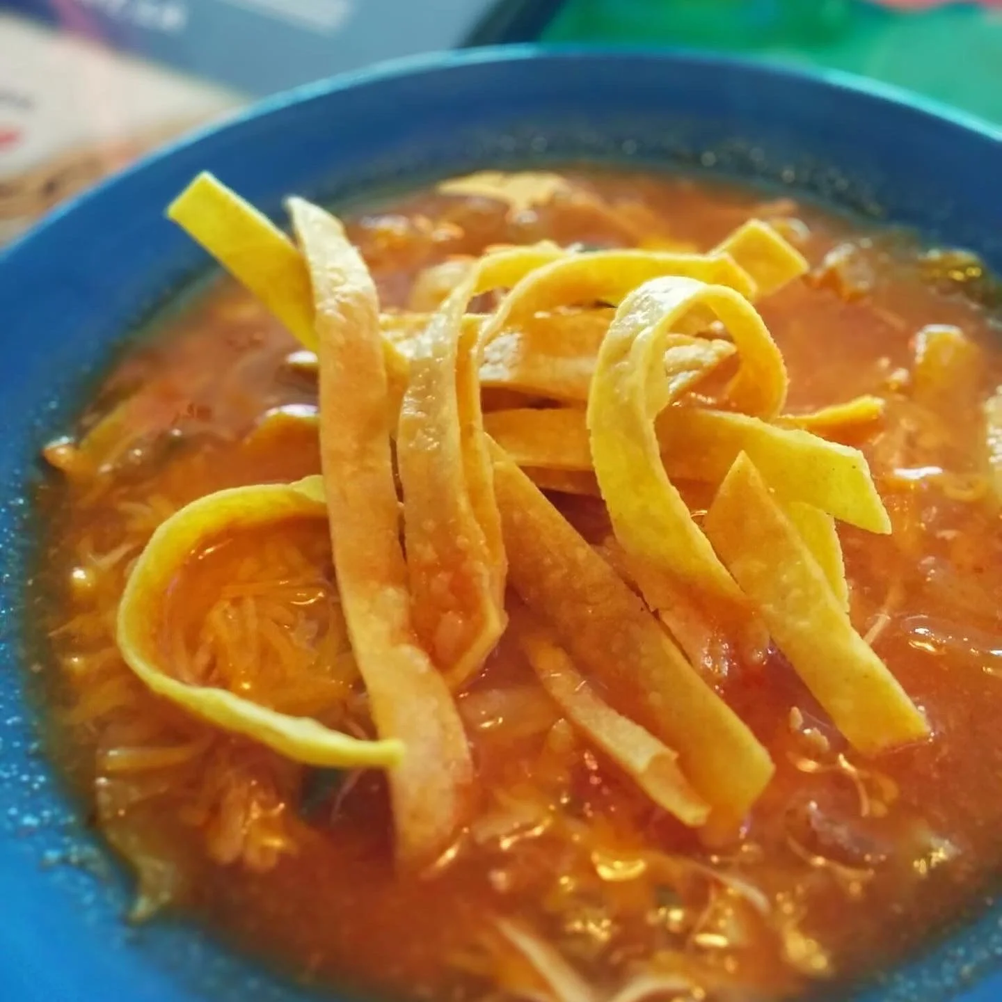 chcken toritilla soup with fresh tortilla chips topping and cheese