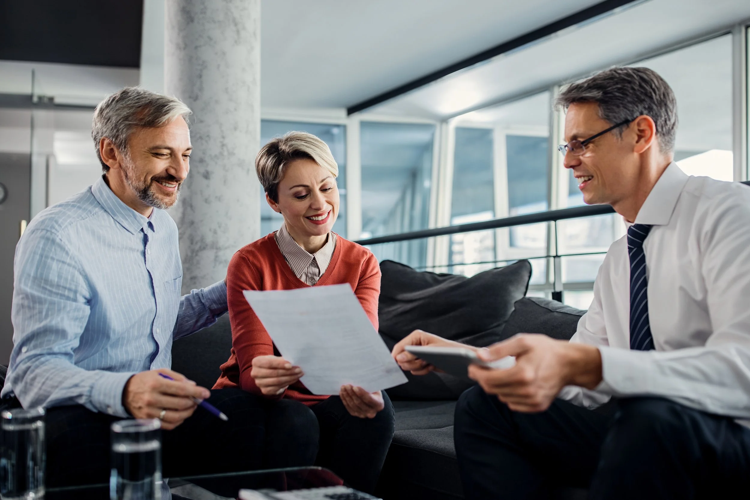 happy-couple-financial-advisor-going-through-plans-meeting.jpg
