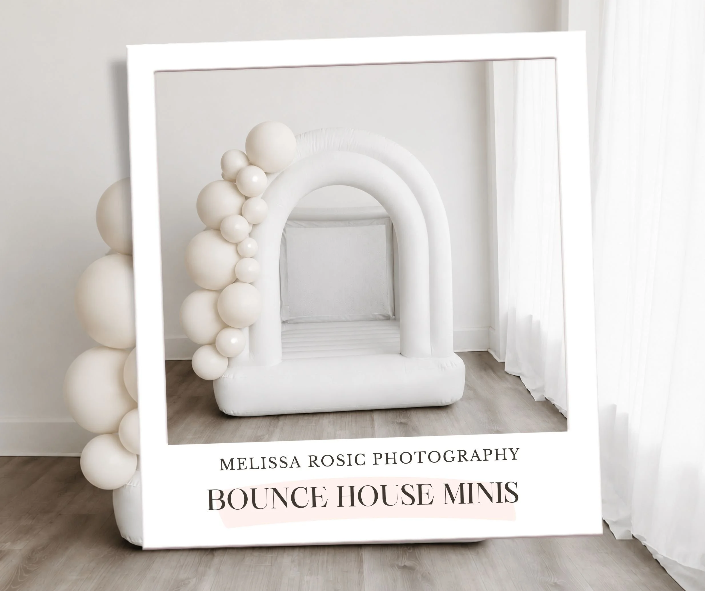 Display board with pink and white balloons on the left side, advertising Bounce House Minis by Melissa Rosic Photography, placed on a wooden floor near a white wall and sheer curtains.
