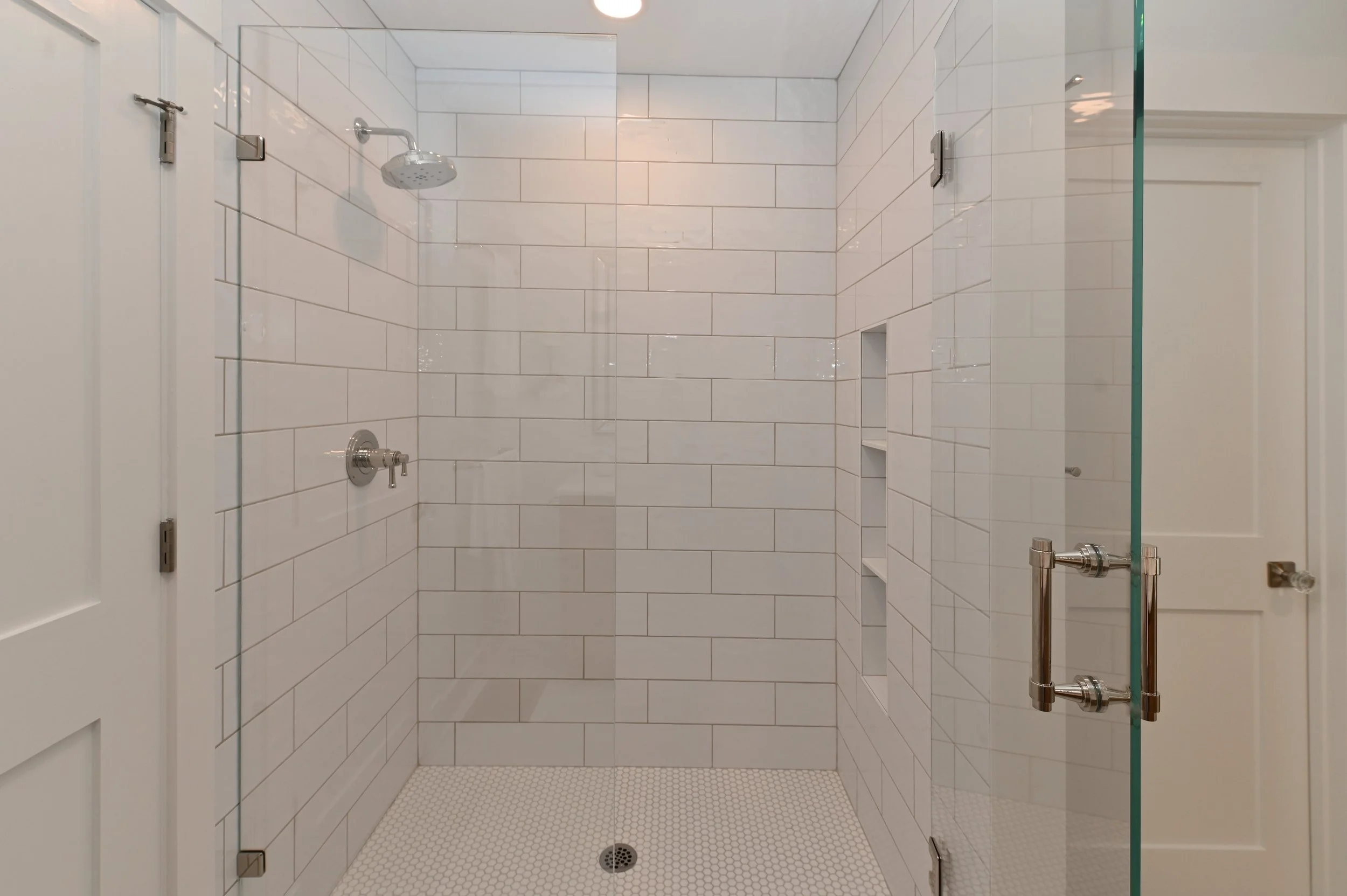 Custom walk-in shower with floor to ceiling tile in Northern Kentucky bathroom remodel by Shade Tree Homes