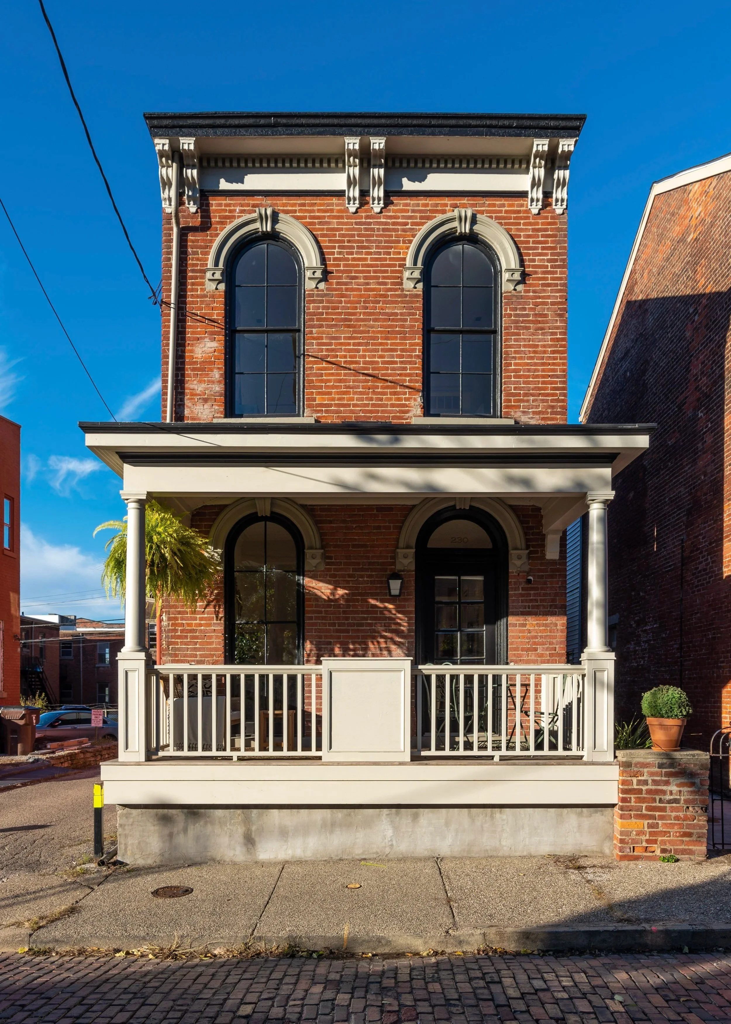 Restored historic brick exterior with arched windows in Covington Kentucky by Shade Tree Homes