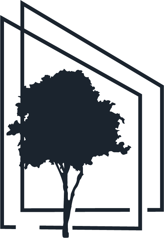 Silhouette of a tree in front of a modern, angular building with large windows.