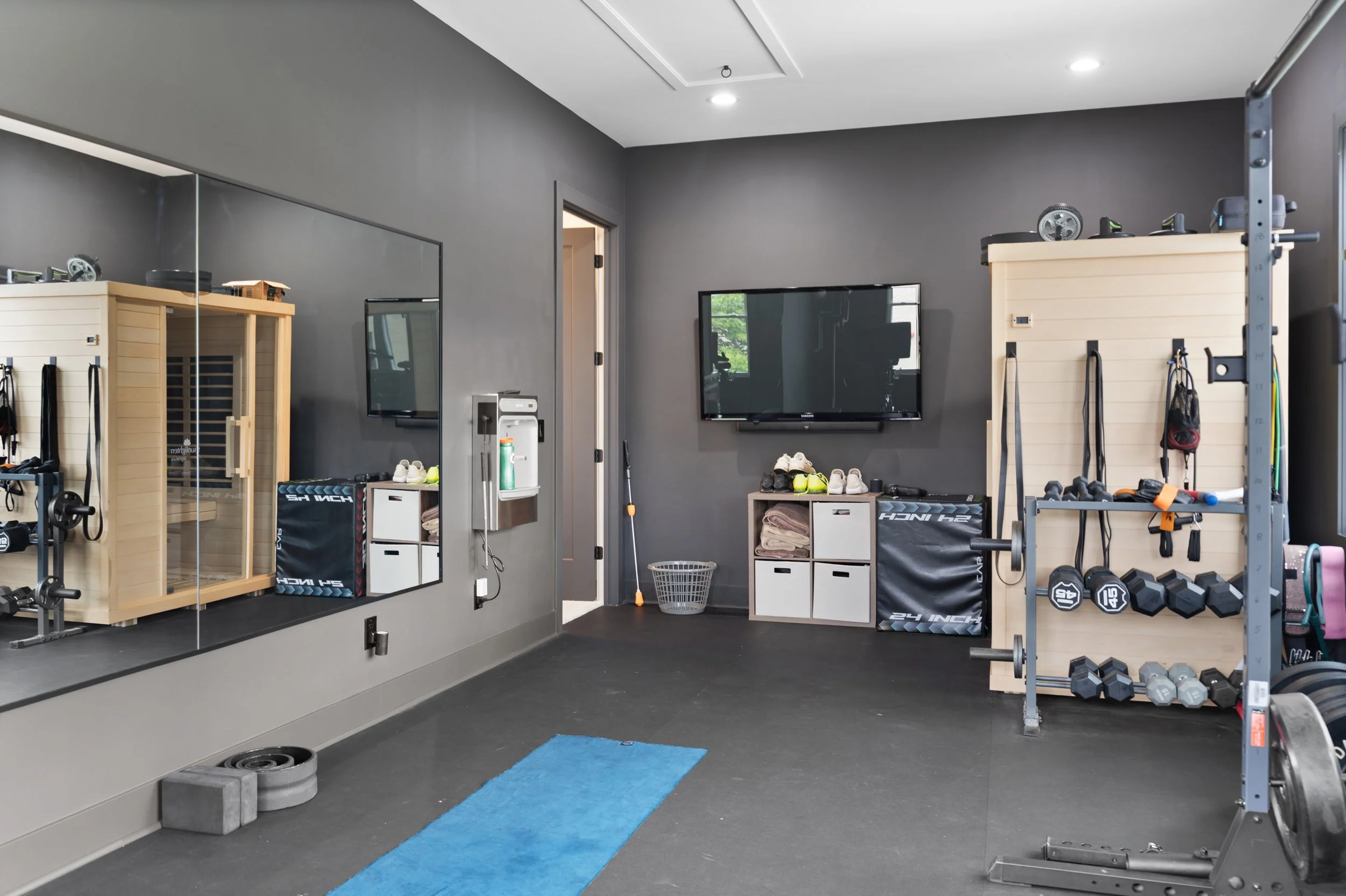 Custom home gym with work out equipment in Fort Thomas Kentucky whole home remodel by Shade Tree Homes