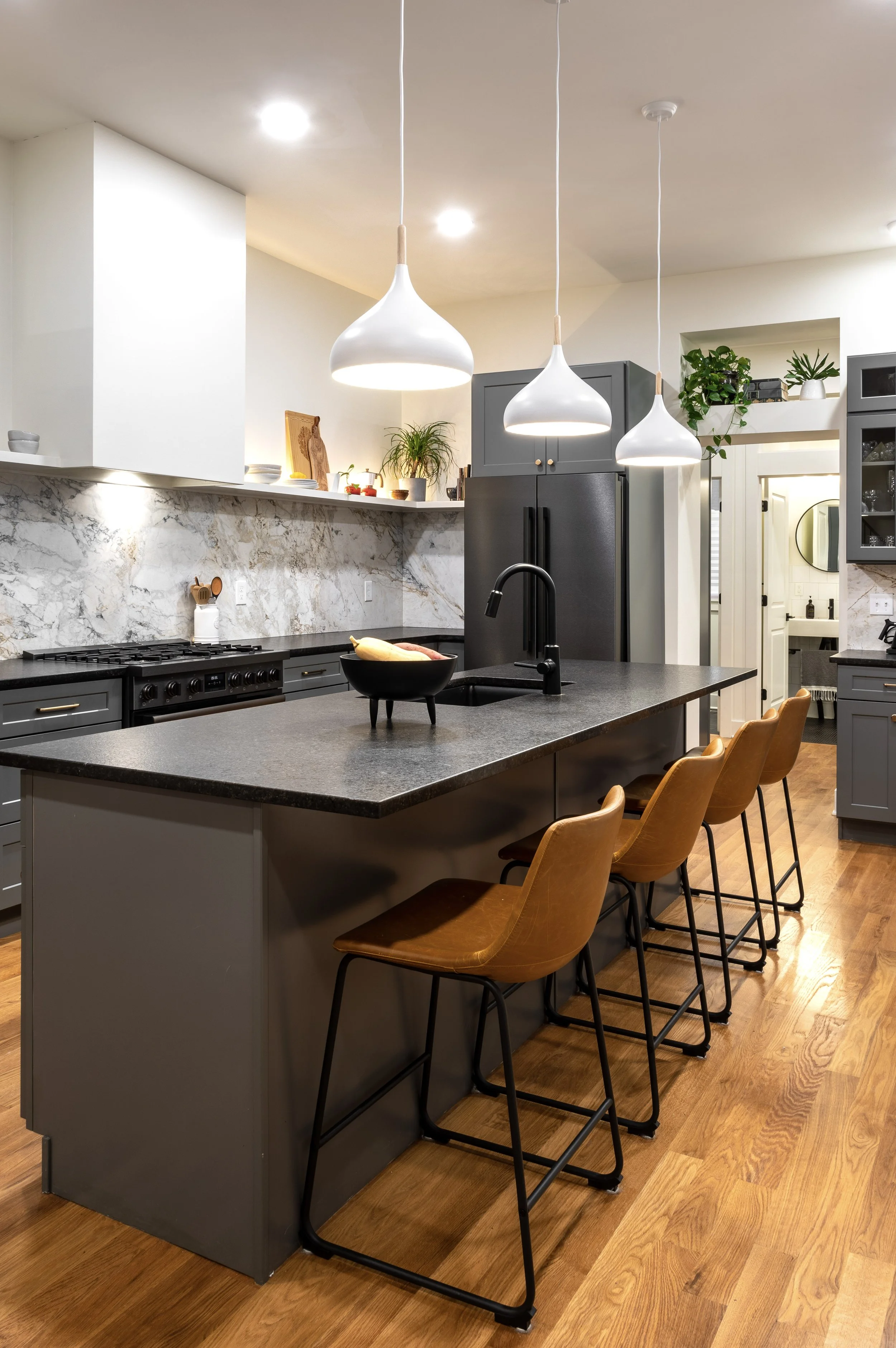 Open kitchen with island seating and pendant lighting in Covington Kentucky historic remodel by Shade Tree Homes