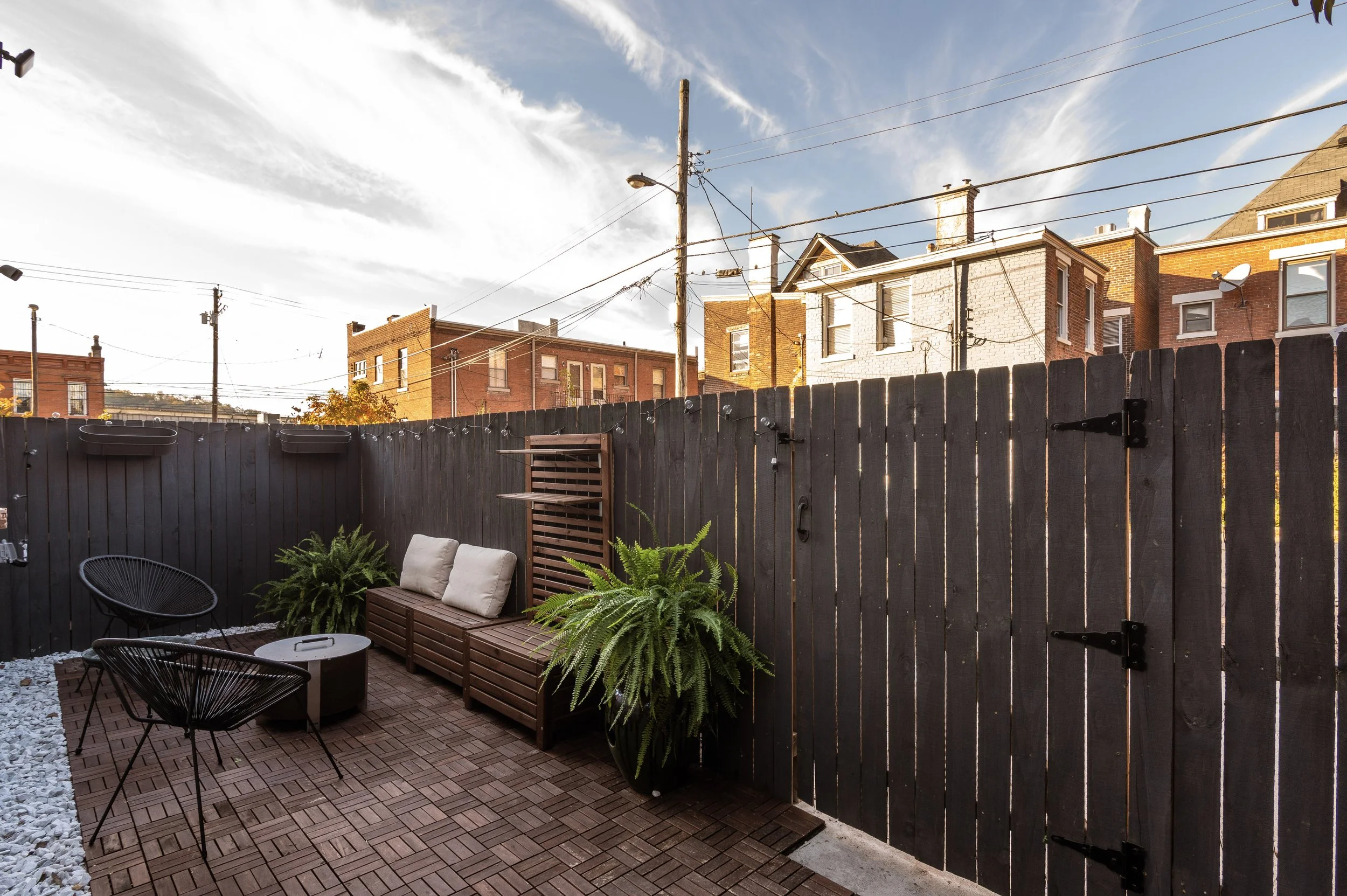 Custom rear outdoor living area in historic Covington Kentucky home remodel by Shade Tree Homes