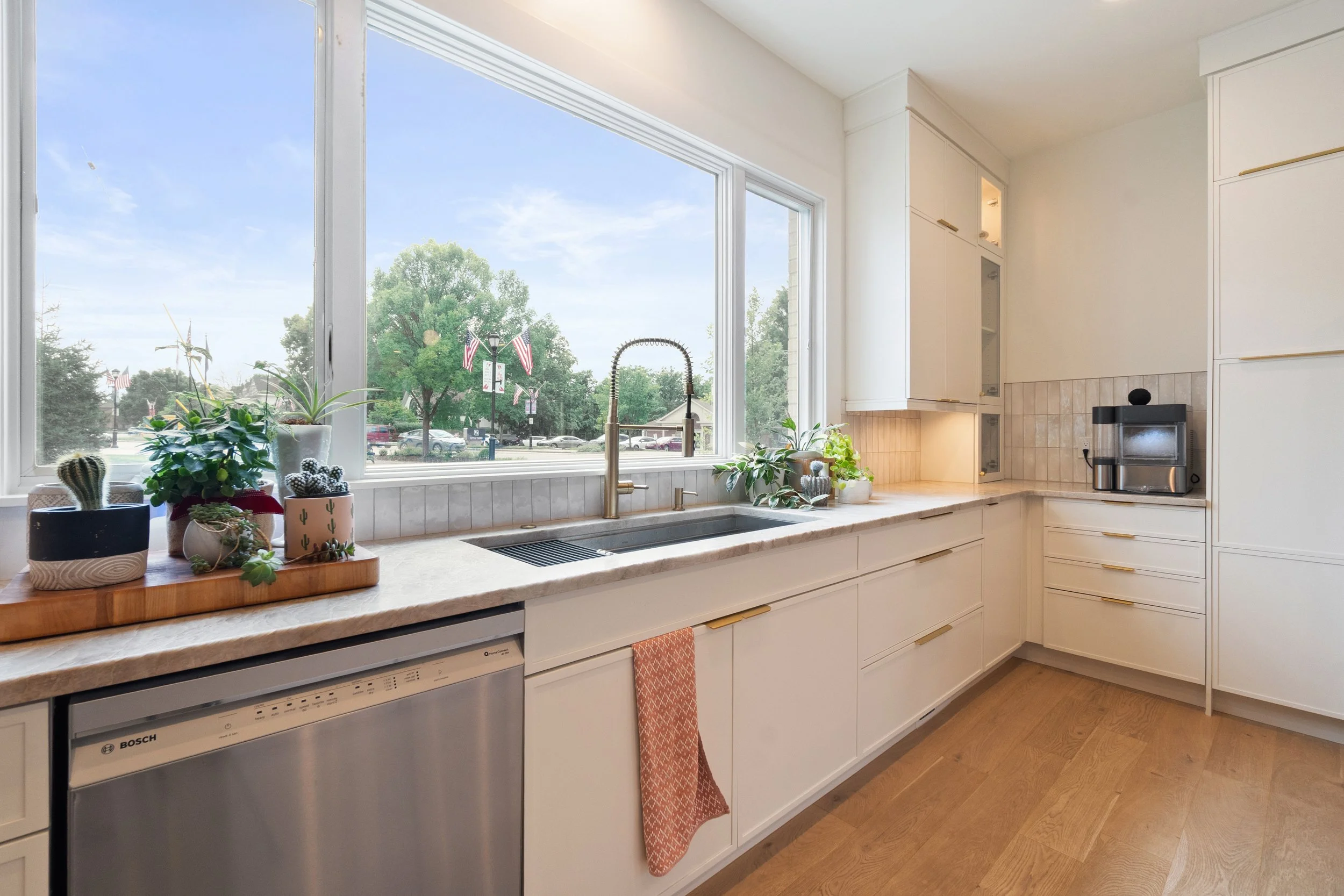 Kitchen sink wall with picture window overlooking exterior in Fort Thomas Kentucky remodel by Shade Tree Homes